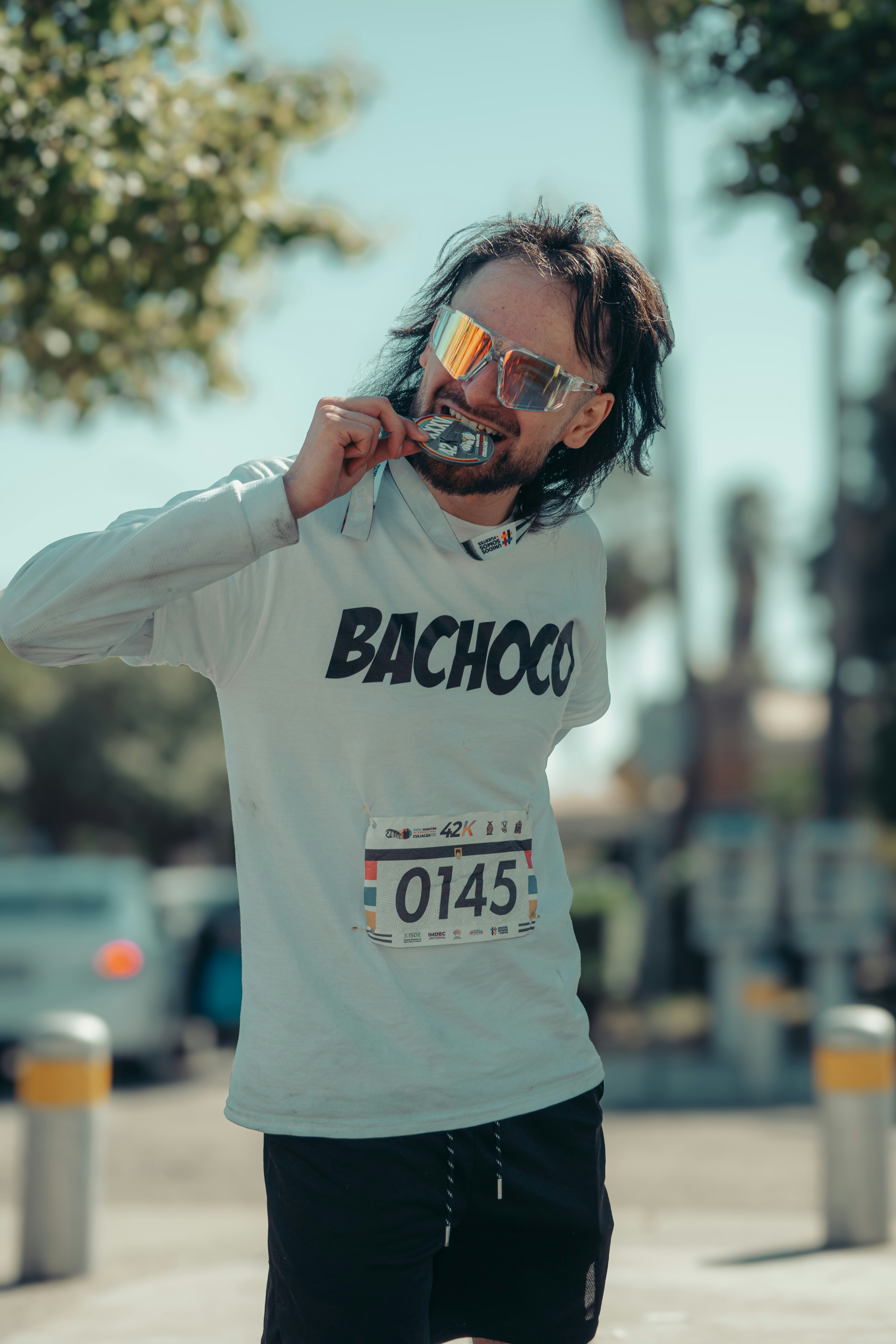 Man with sunglasses eats ice cream after race