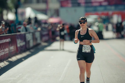 Woman running a marathon with bib number 0124
