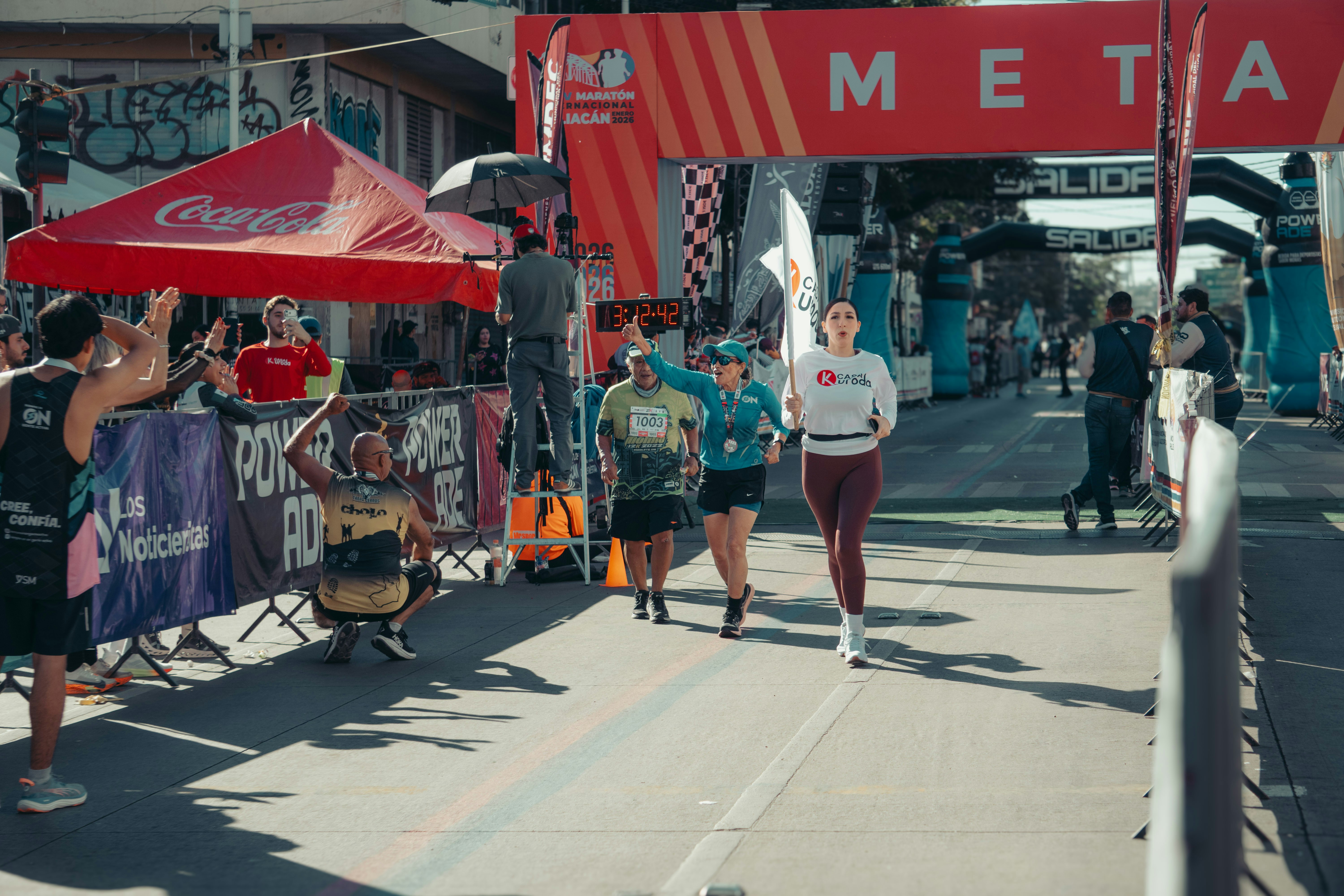 A marathon runner pushing towards the finish line, symbolizing the long-term commitment and consistent effort required for sustained success in professional proprietary trading.
