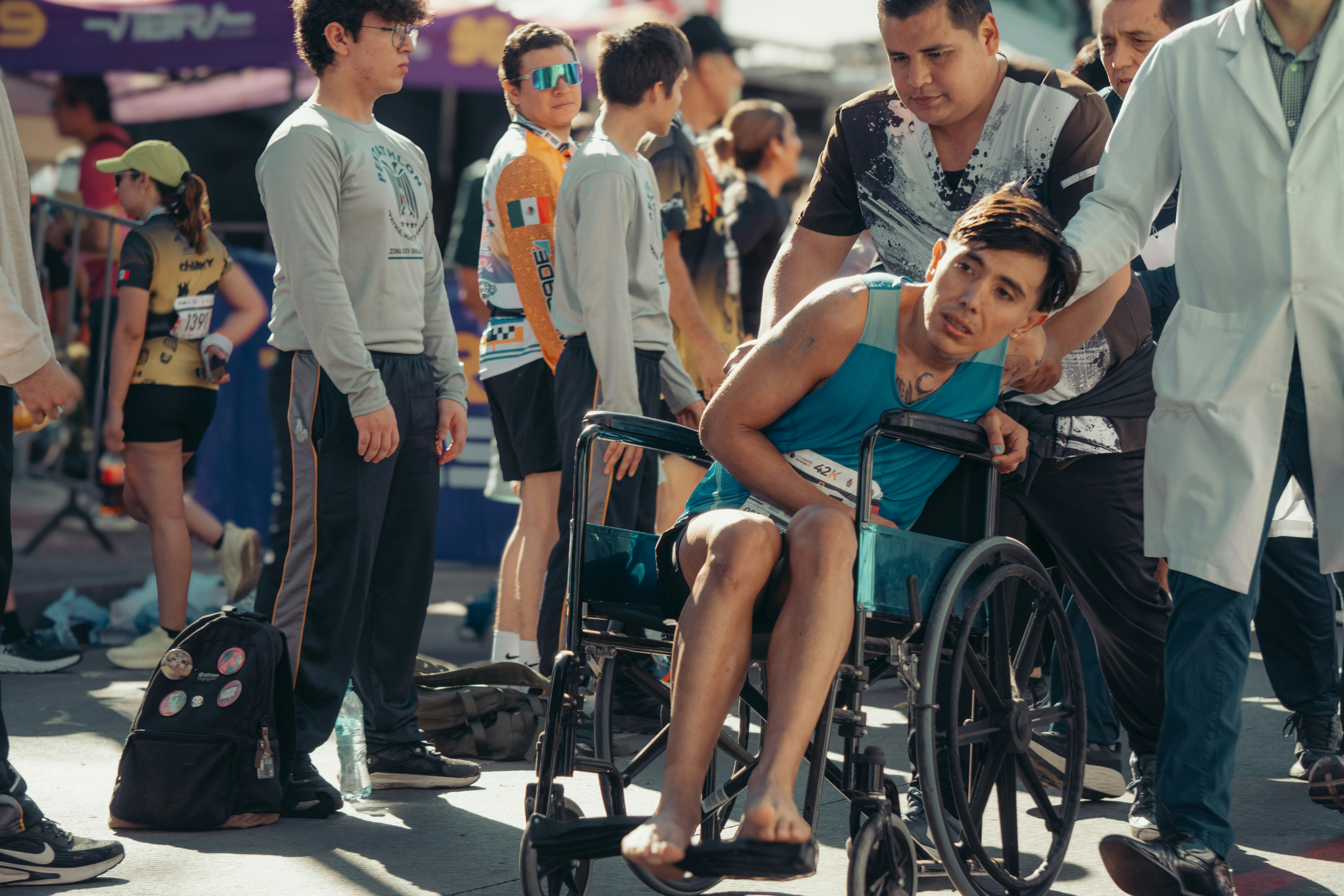 Athlete in wheelchair being helped by medical staff