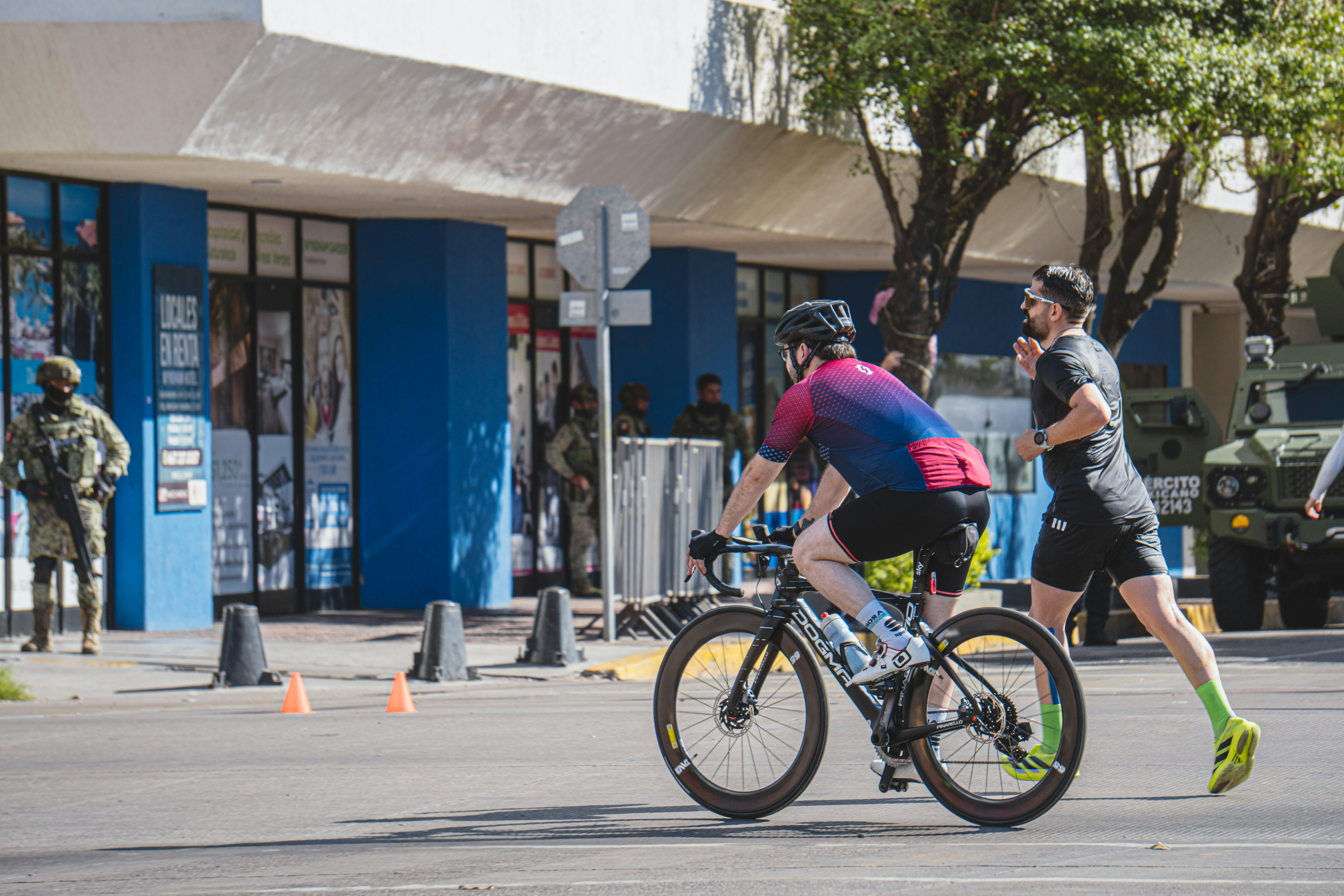 Cyclist and runner race on a city street
