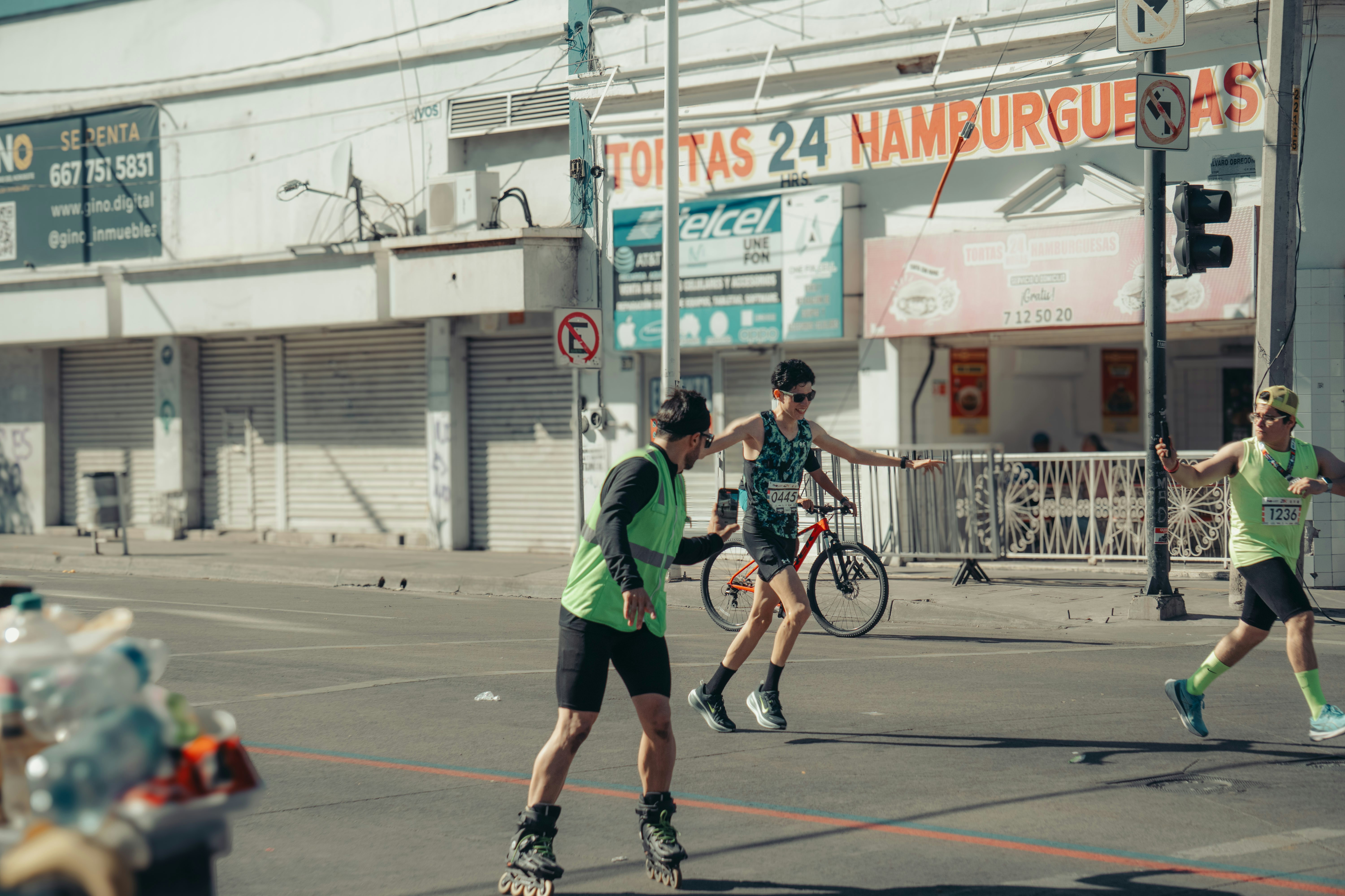 People rollerblading and cycling on a street