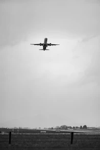 Airplane ascending into a cloudy sky.