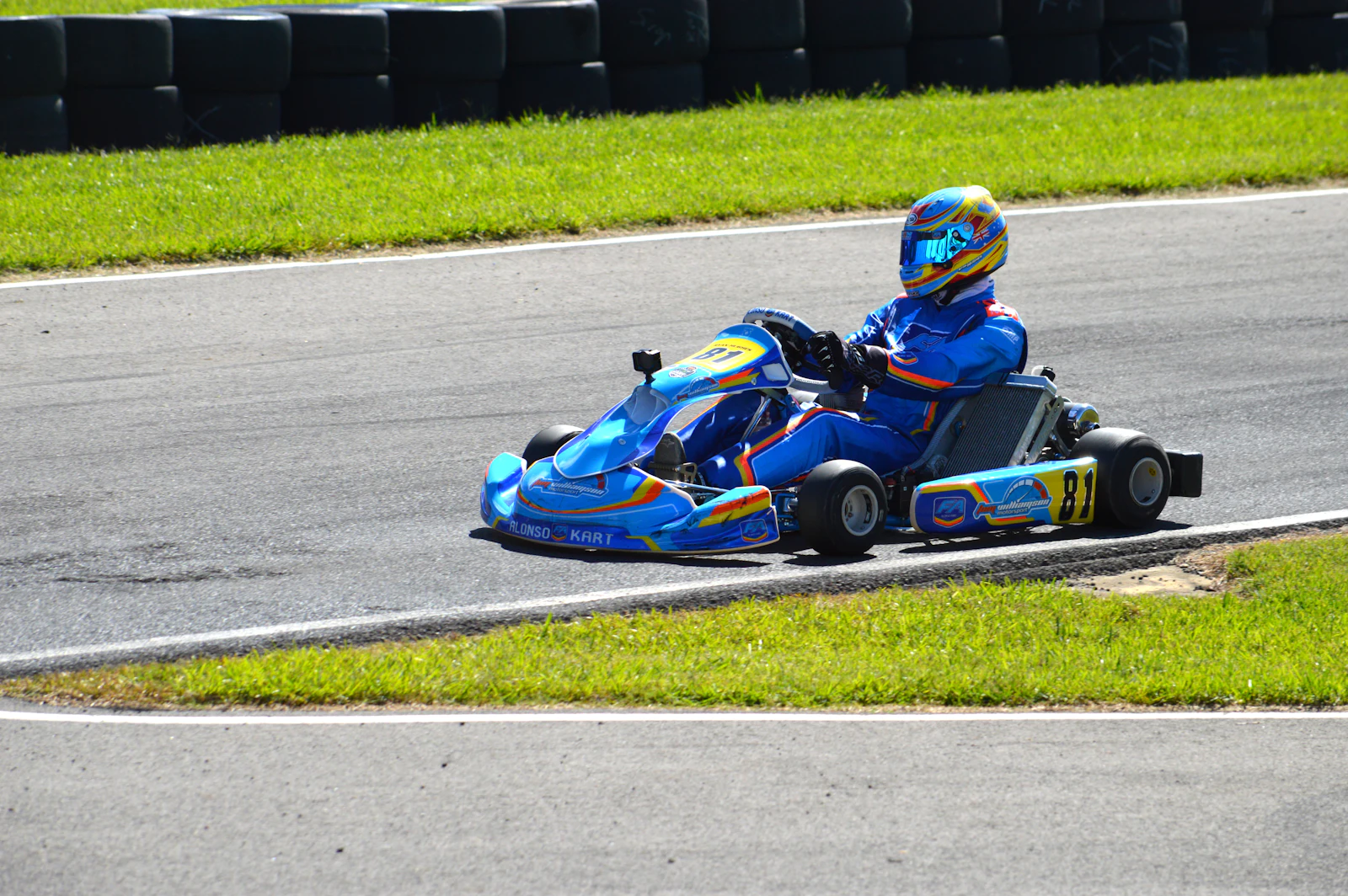 A blue race kart on the limit through a corner