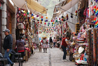 Colorful market stalls line a narrow cobblestone street