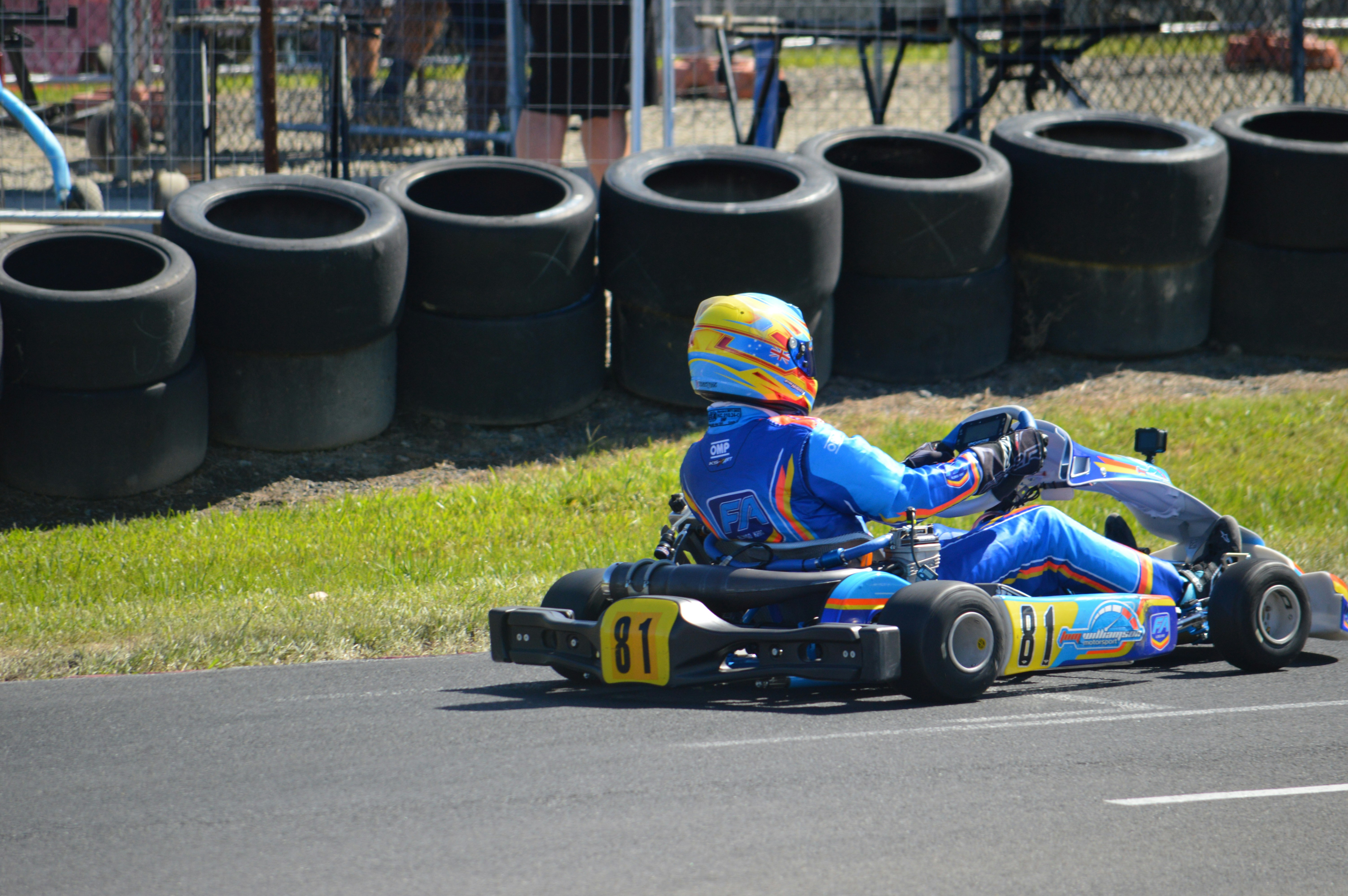 A go-kart racer in a blue suit on a track. photo – Free Sport Image on ...