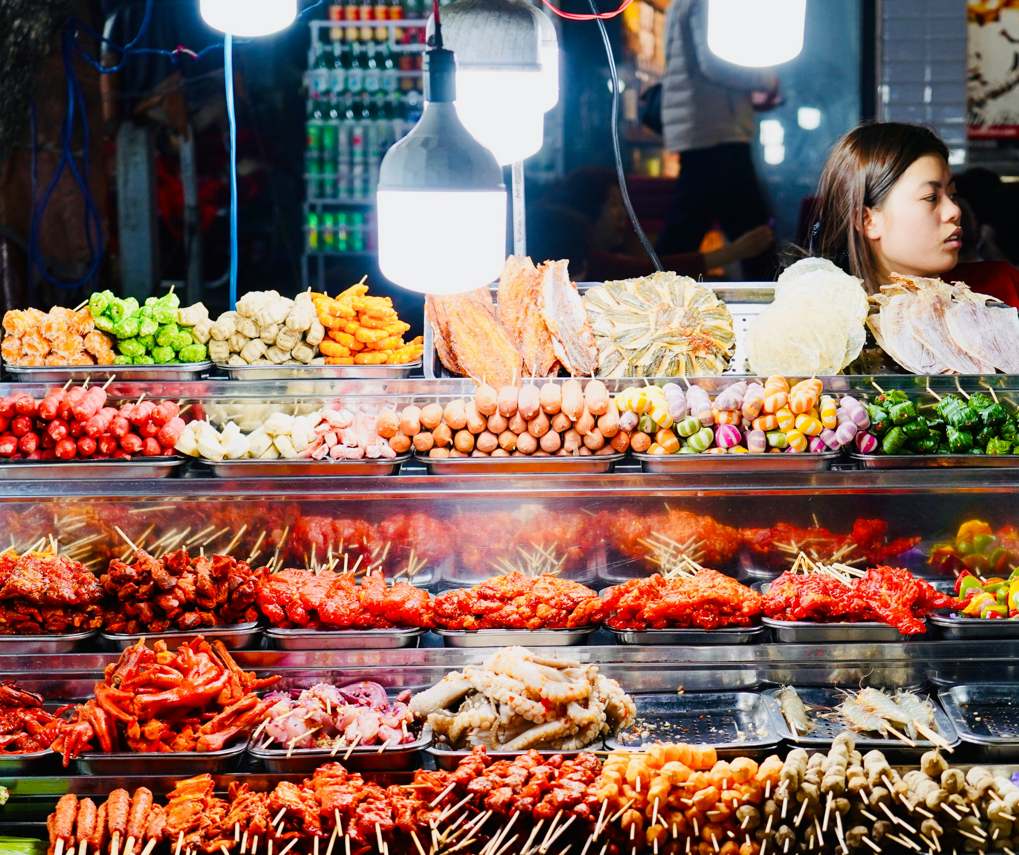 Street food stall with various skewers and ingredients