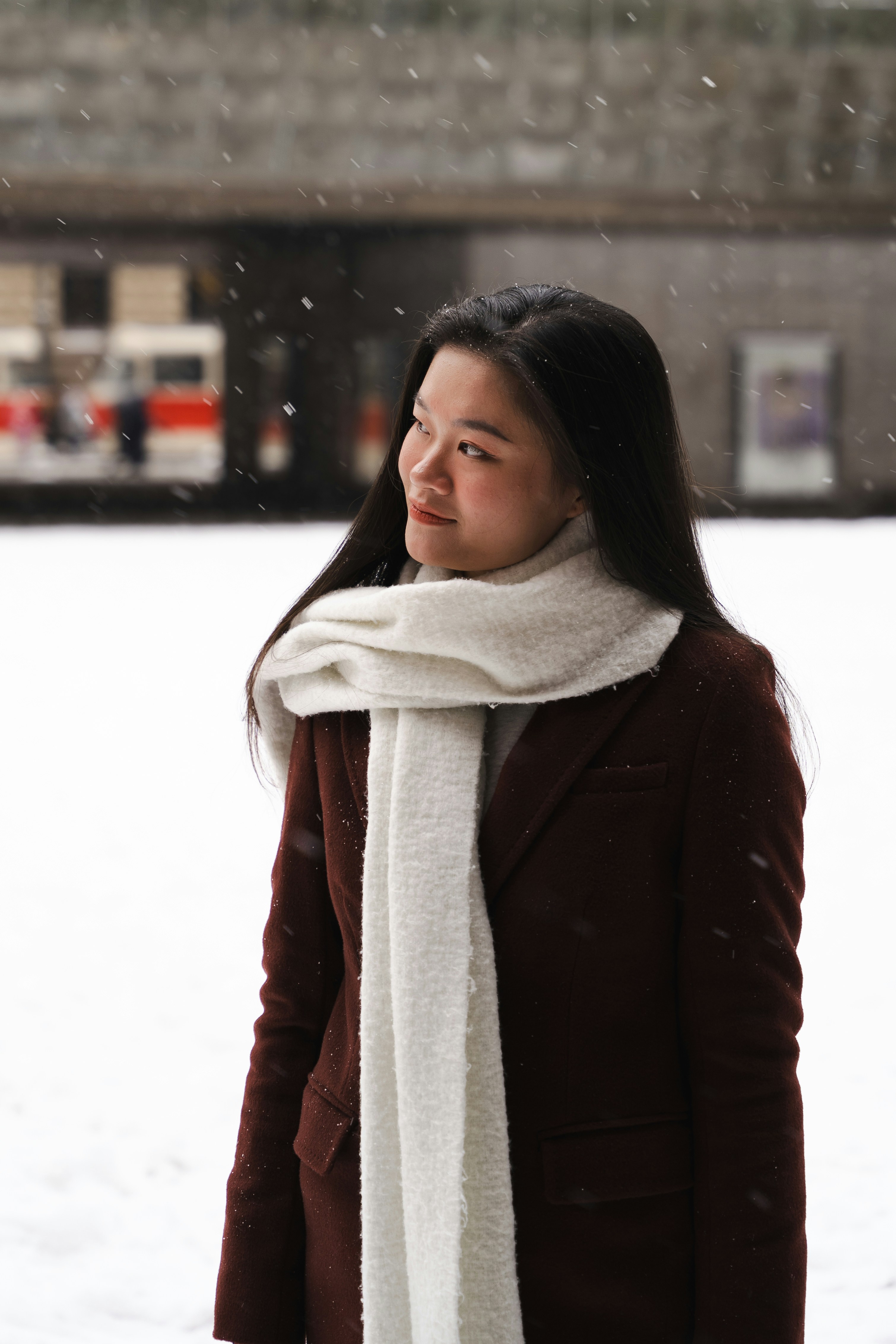 A woman wearing a scarf in the snow