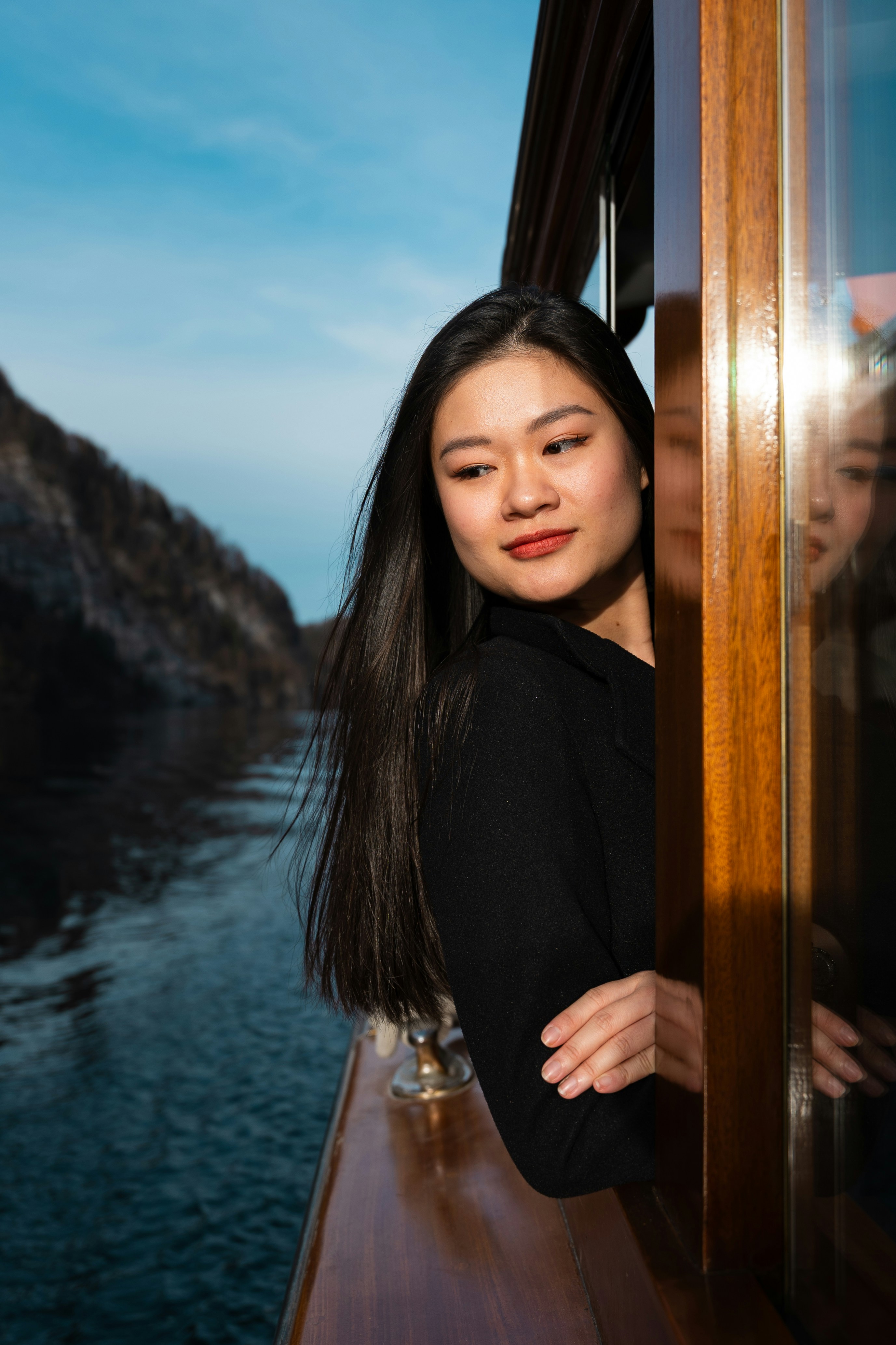 Young woman looking out window on a boat