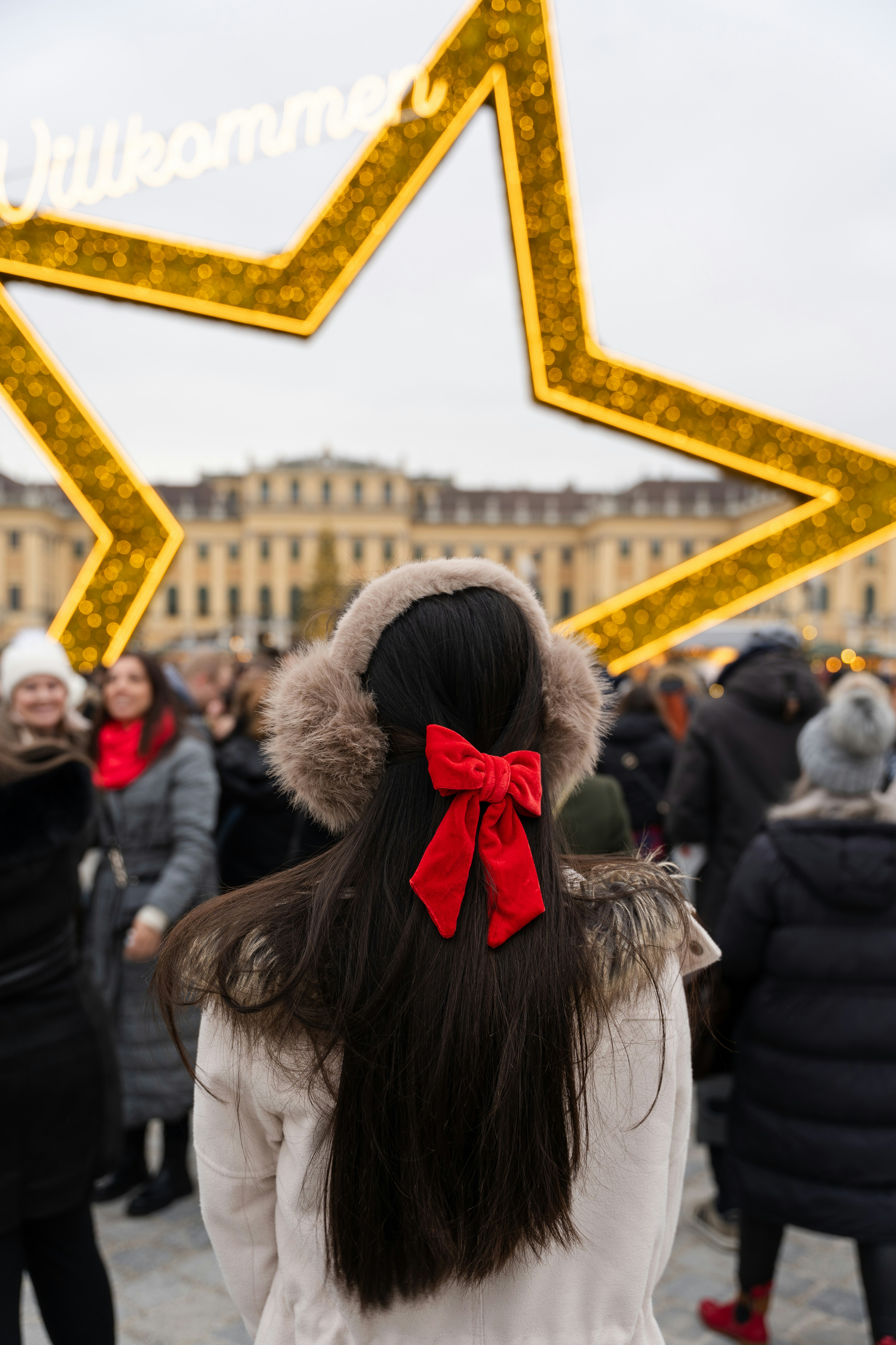 Woman with red bow at christmas market