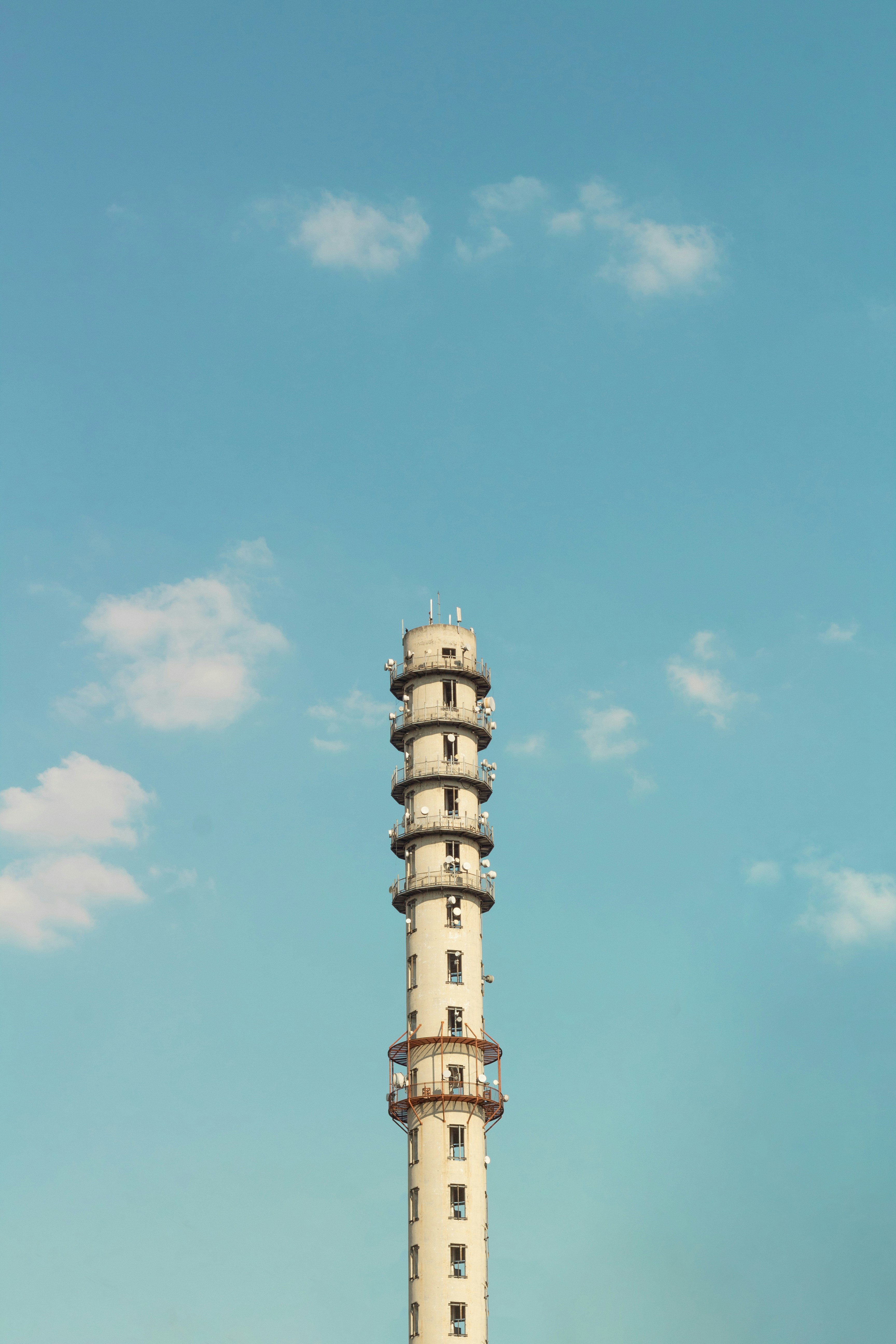 Haute tour en béton avec balcons circulaires sur un ciel bleu