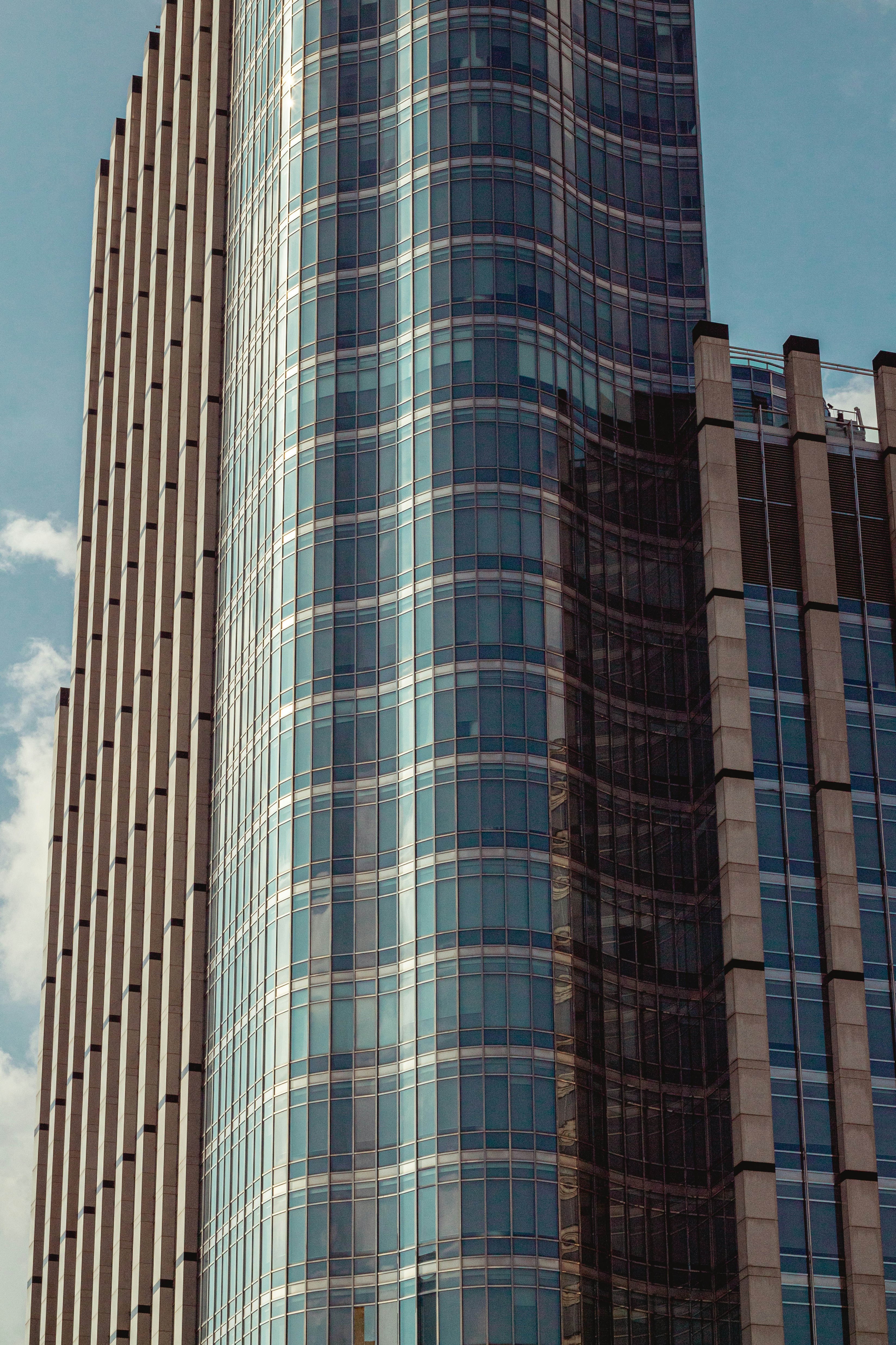 Gratte-ciel moderne en verre avec des lignes verticales contre le ciel