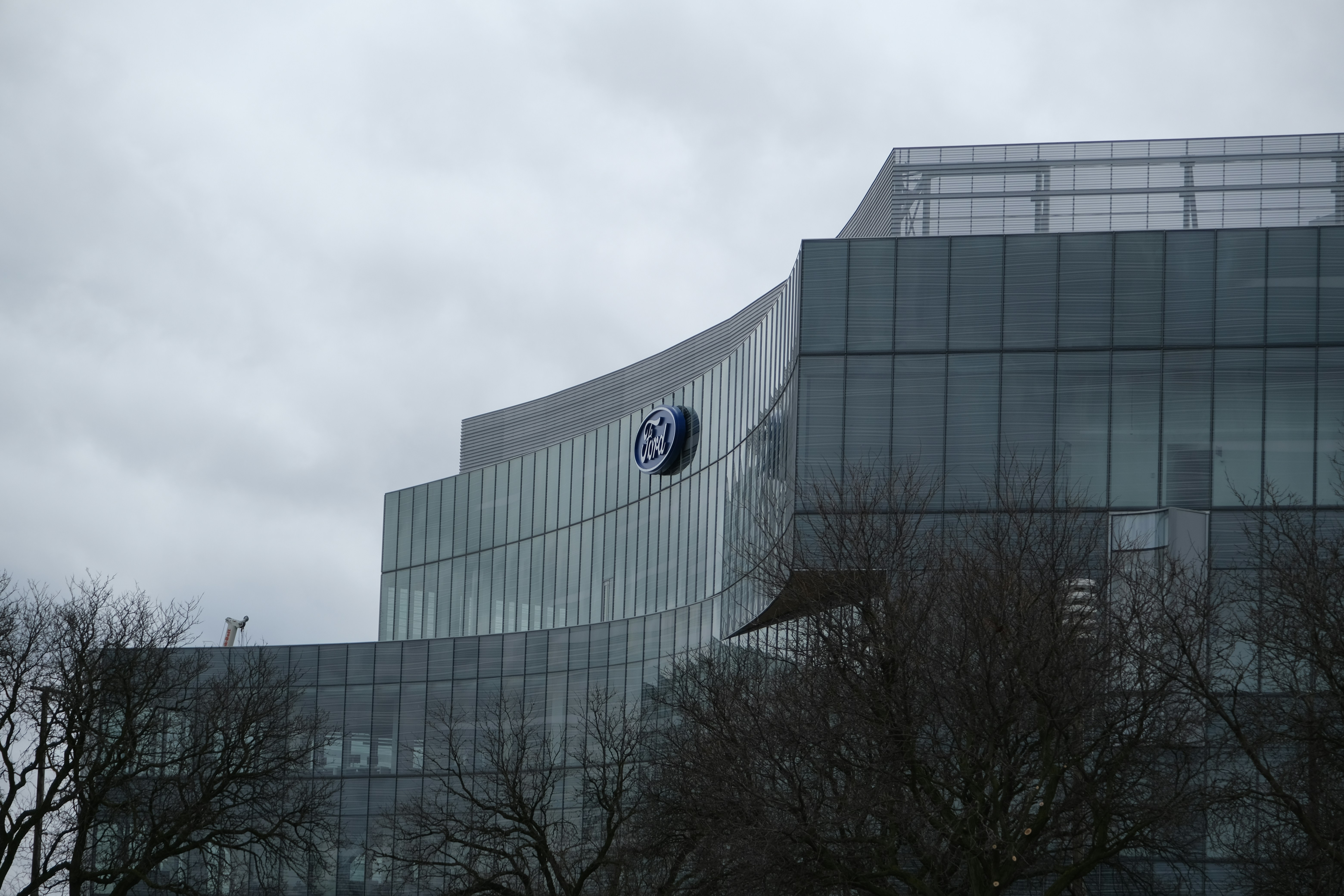 Modern glass building with a clock on facade