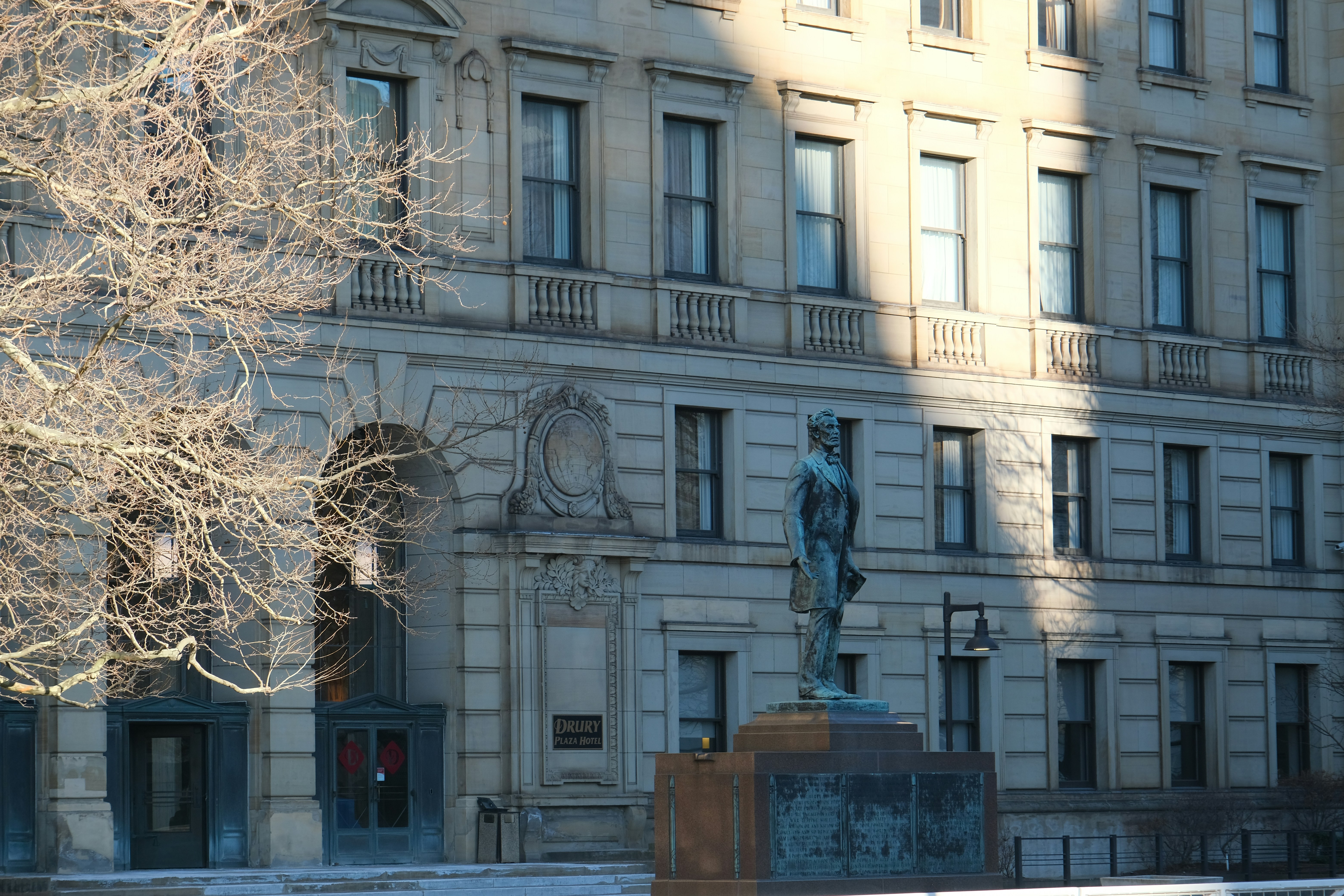 Statue in front of a grand stone building