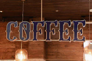 Decorative "coffee" sign hanging in a cafe