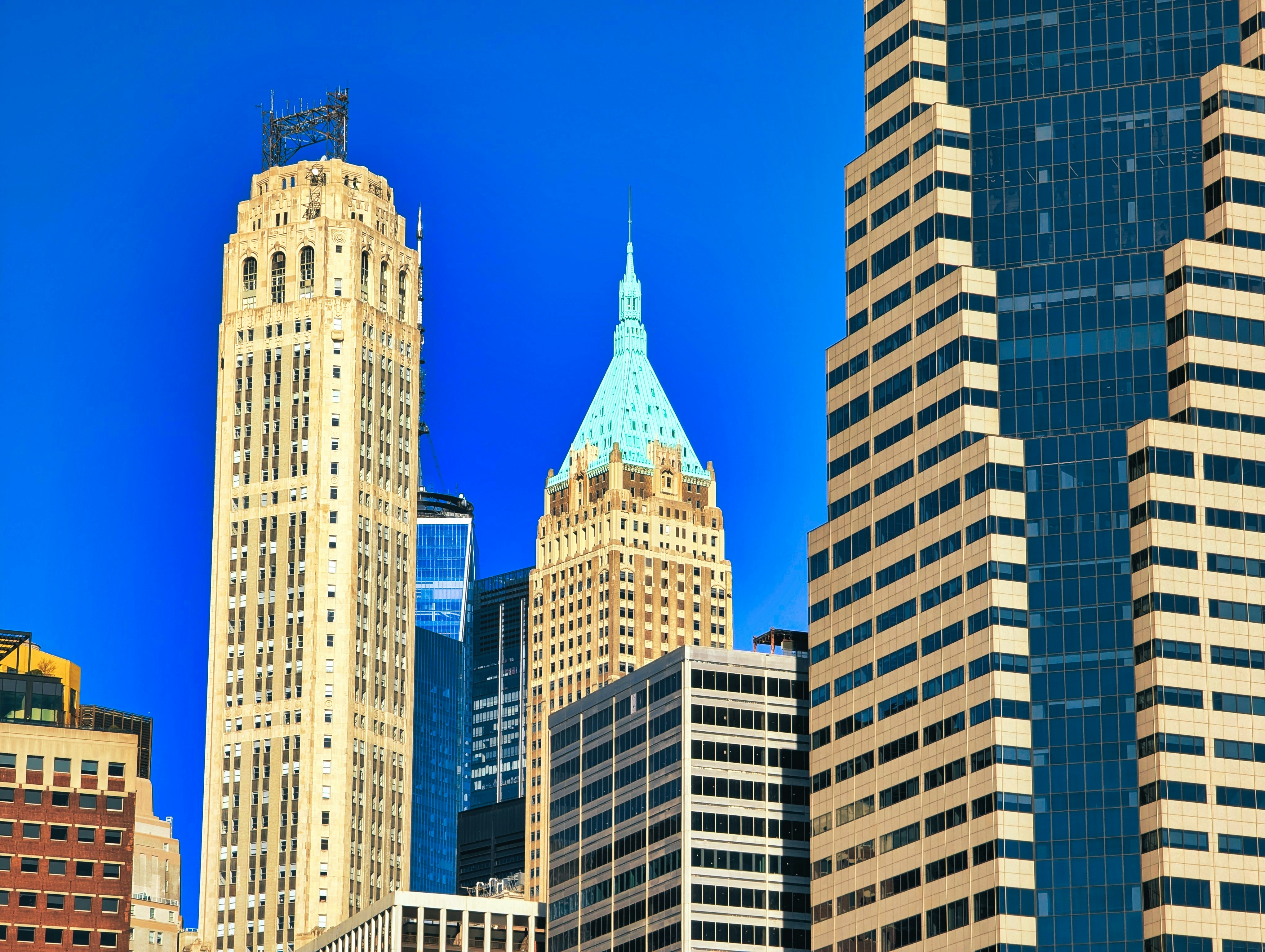 Modern skyscrapers against a bright blue sky