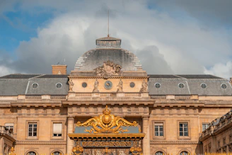 Ornate golden gate in front of historic building
