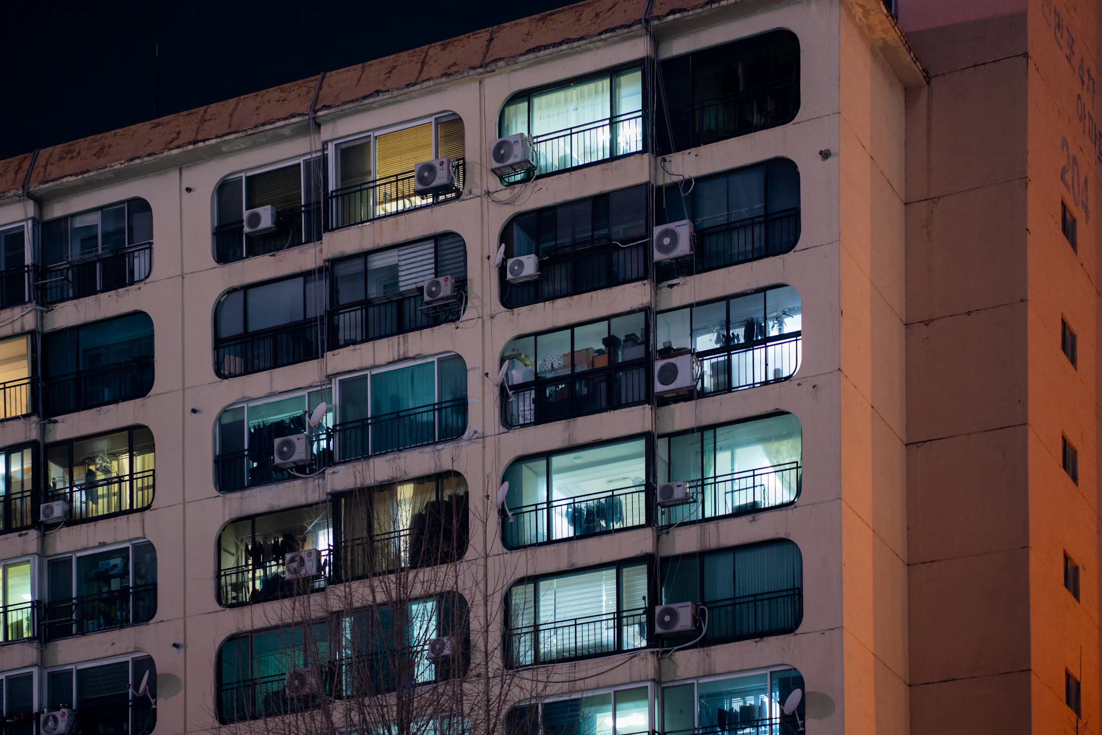An apartment building with lit windows at night