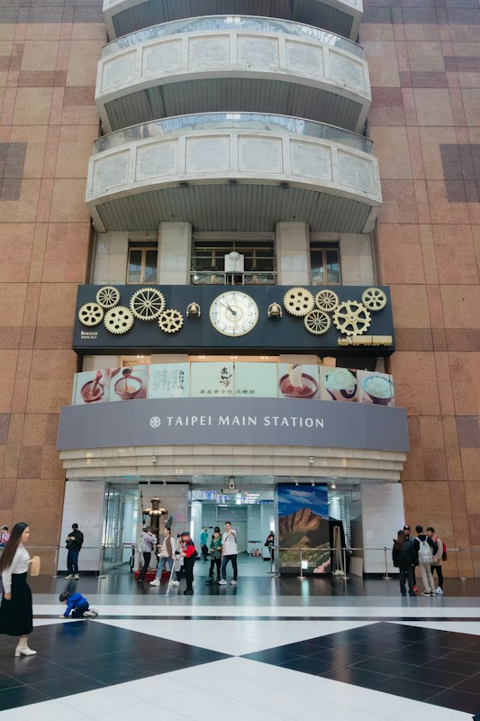 The TAIPEI MAIN STATION sign and gear clock above the East Gate 3 entrance