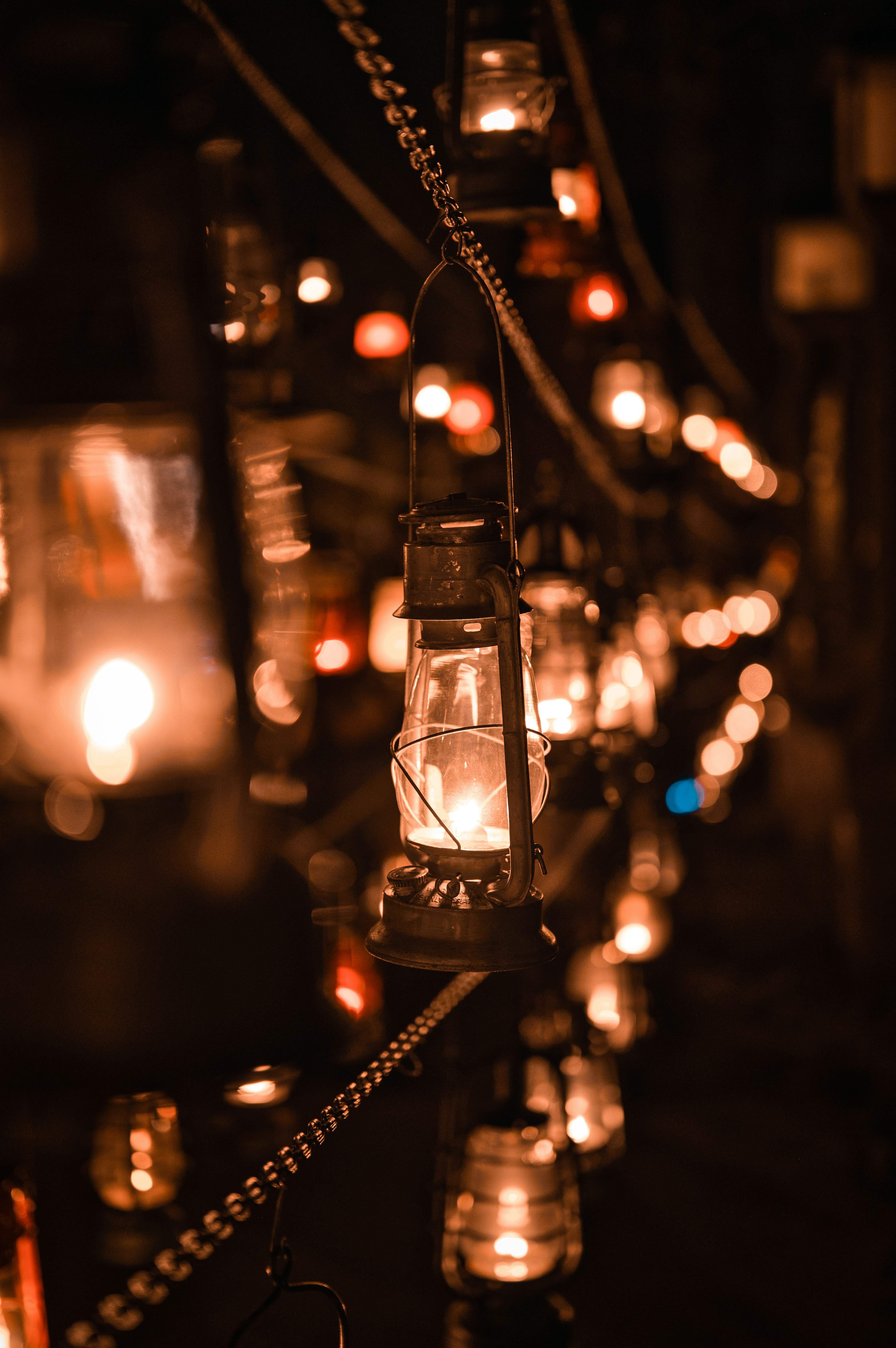 A string of old lanterns glowing at night