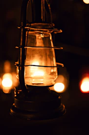 A vintage lantern glows warmly in the darkness