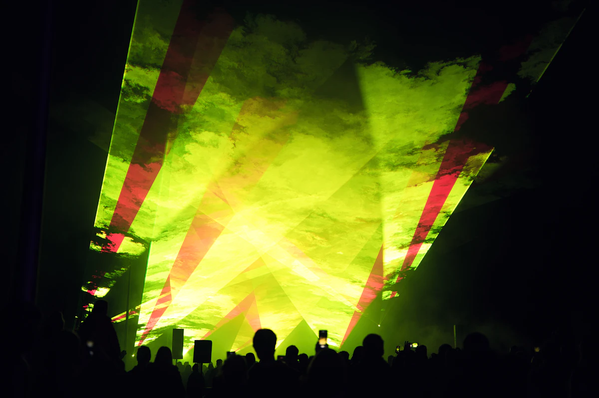 Bright green laser beams spreading across a live audience