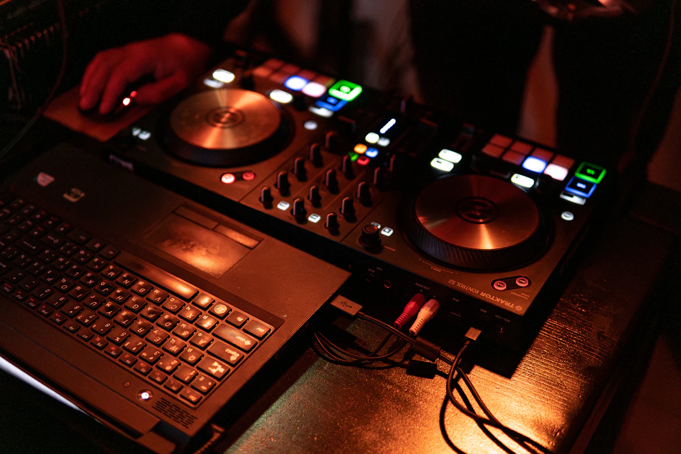 DJ mixing music with a laptop and audio equipment