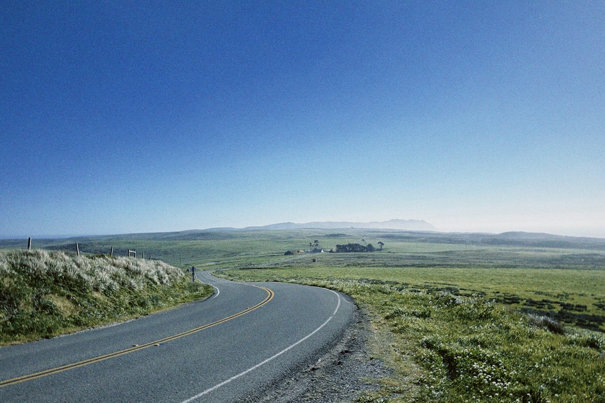 Winding rural road through green countryside