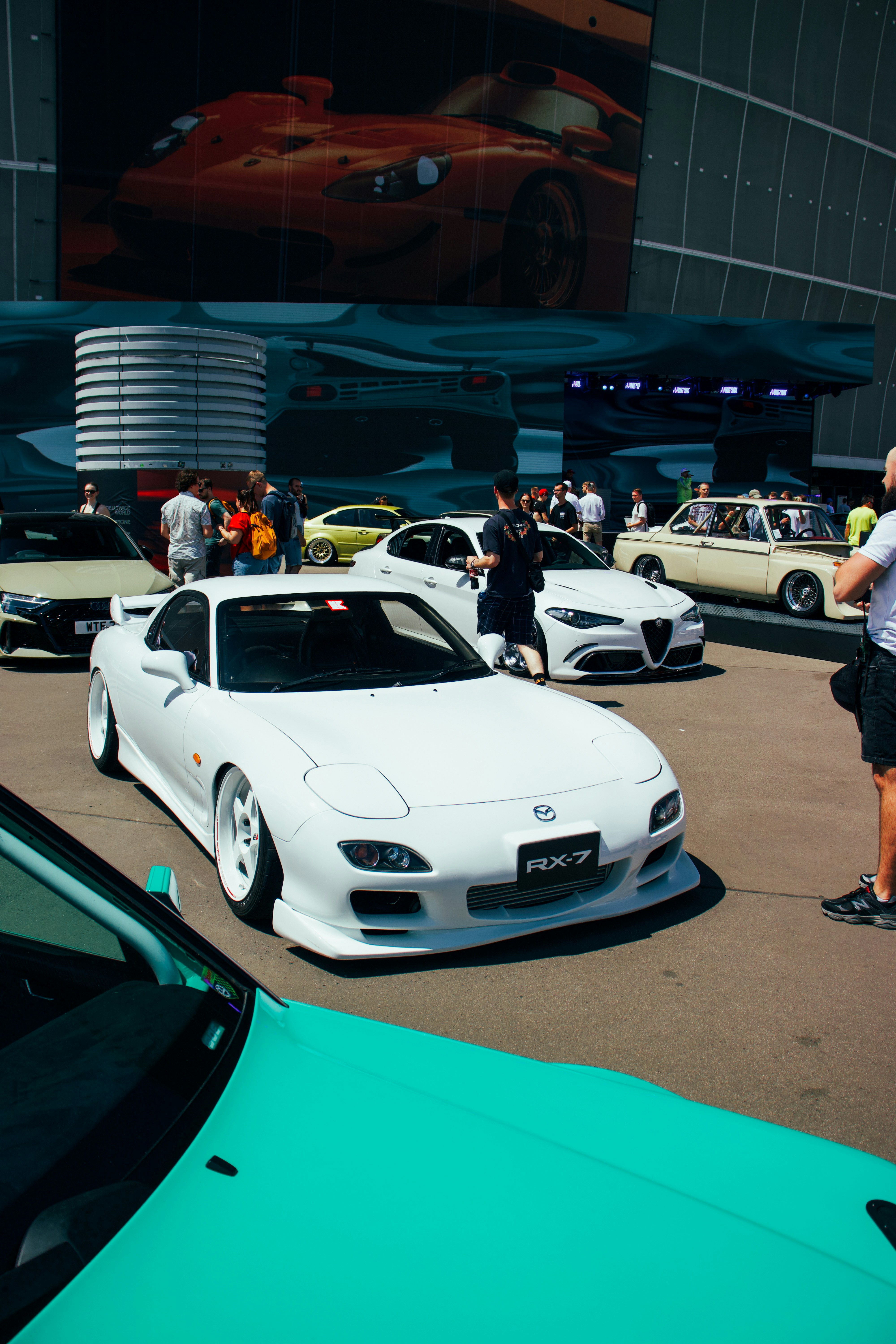 White mazda rx-7 at a car show with spectators
