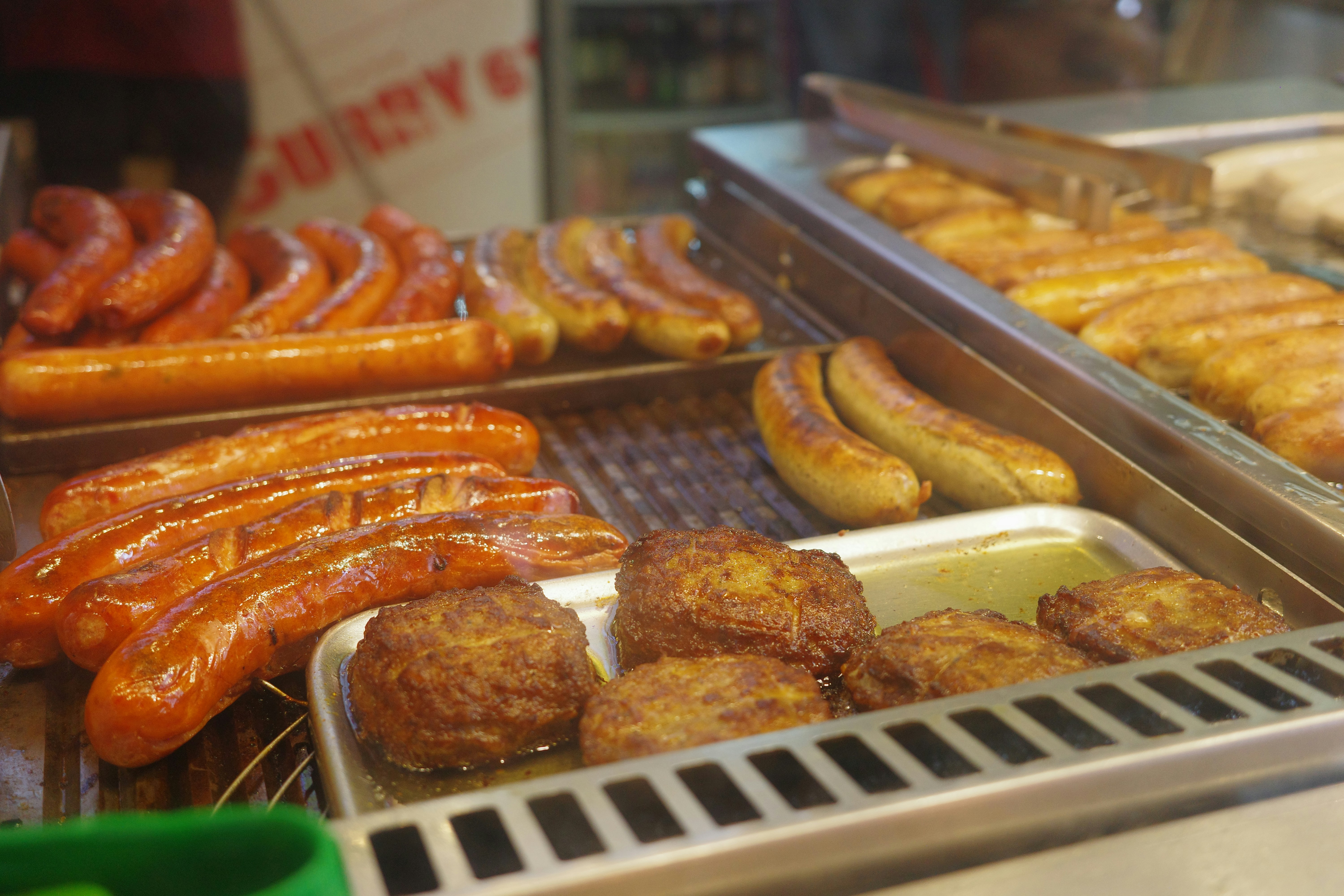 Various sausages and patties displayed in a food case