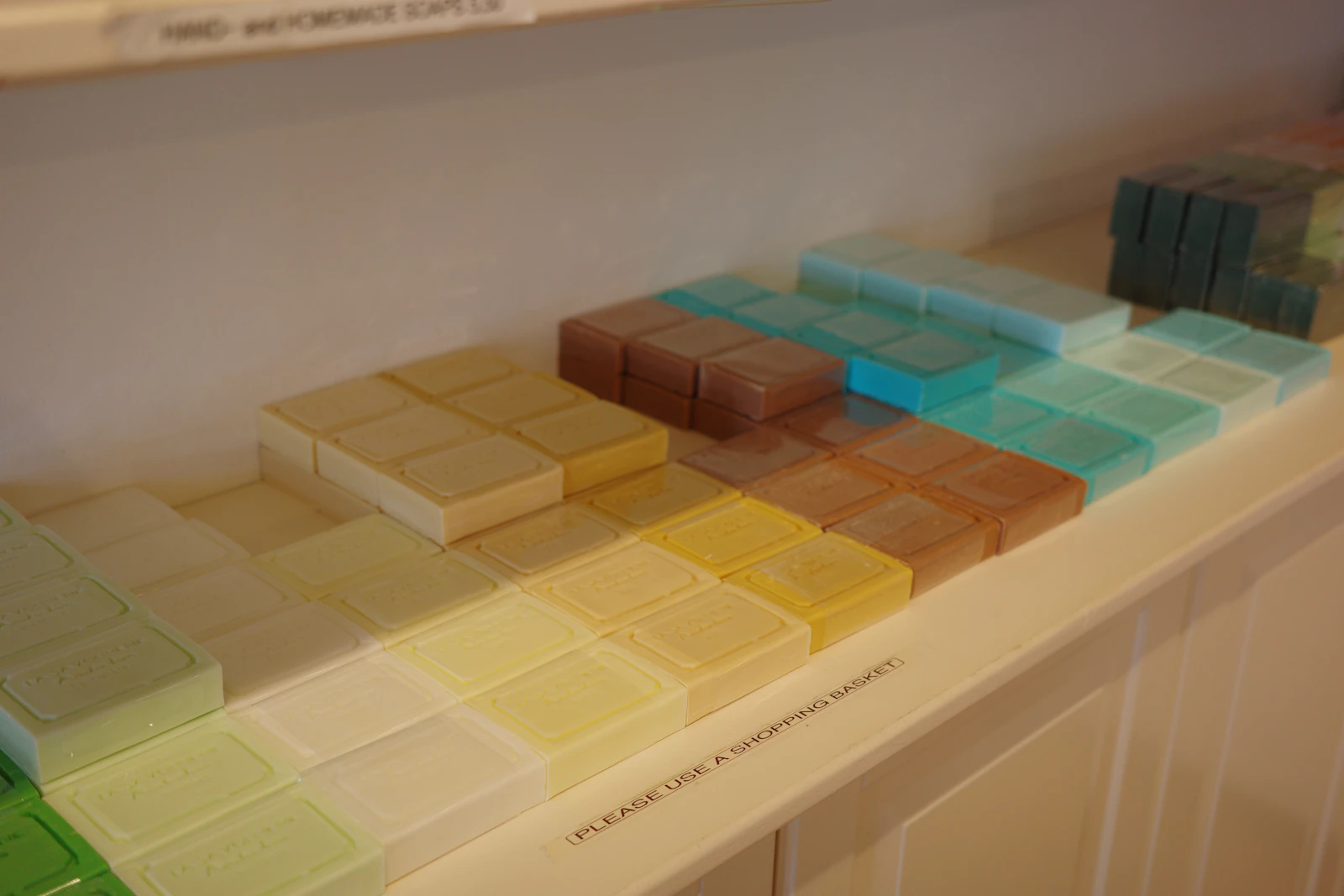 Bars of soap arranged by color on a shop shelf
