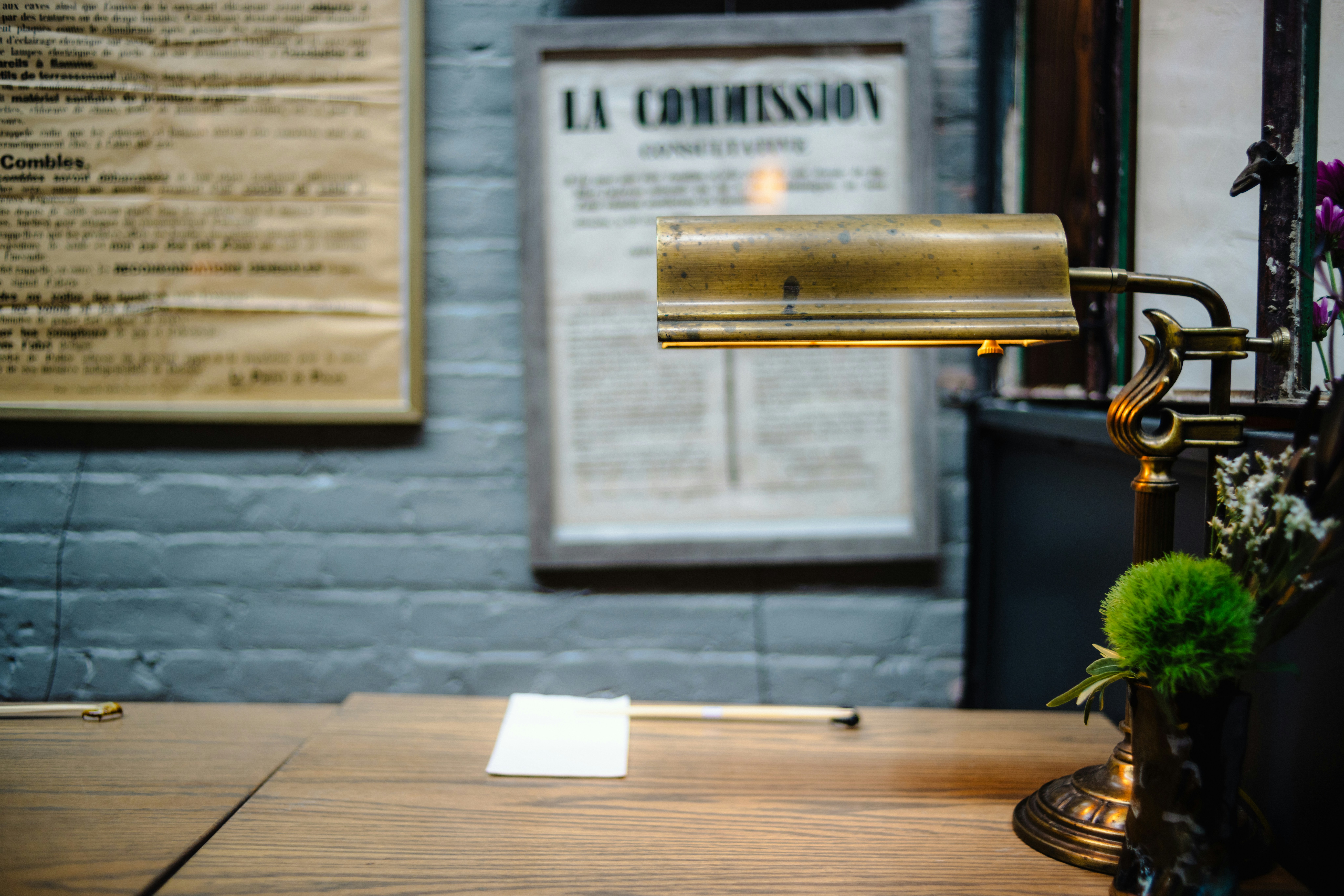 Desk with vintage lamp and framed document