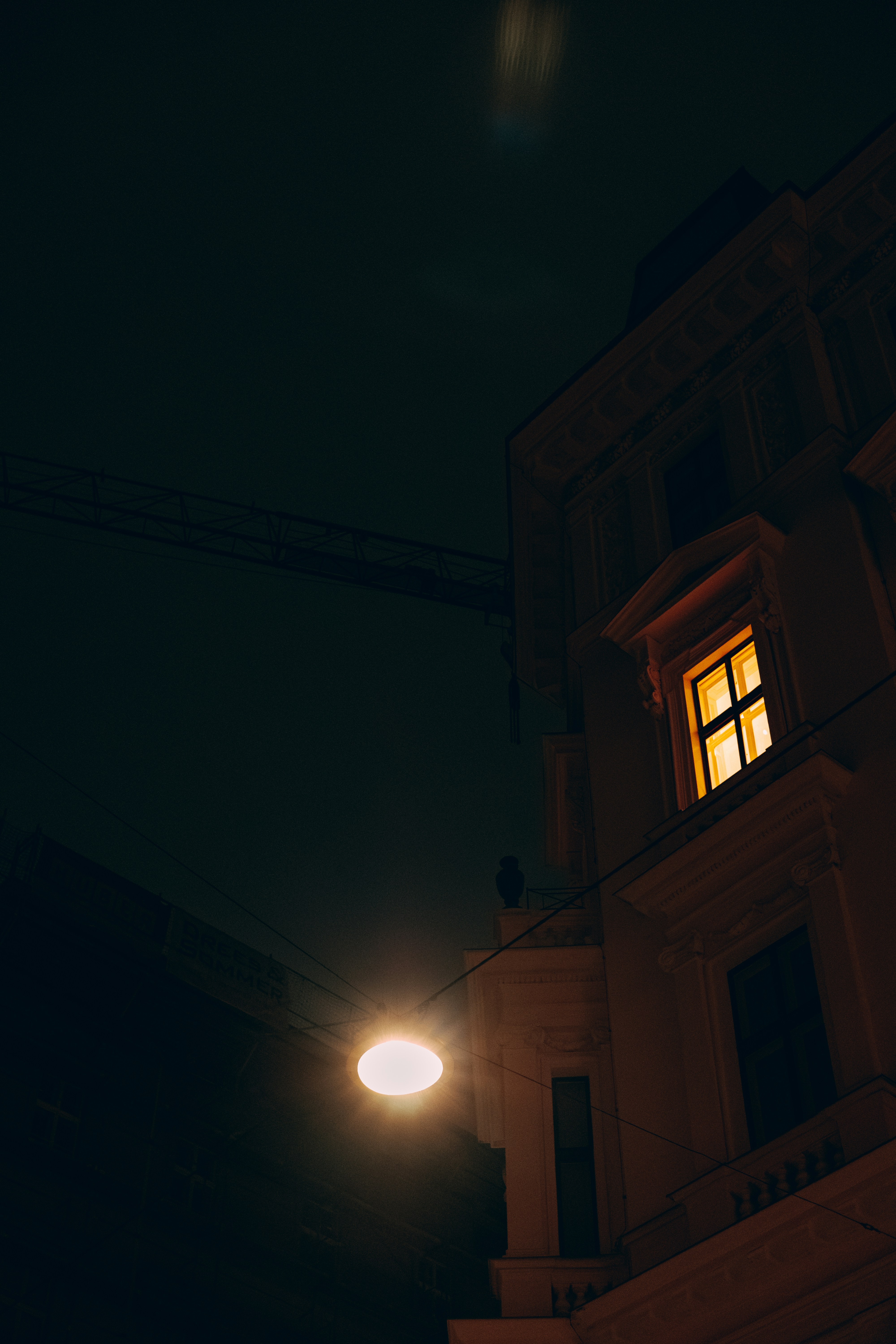 A lit window in a building at night.