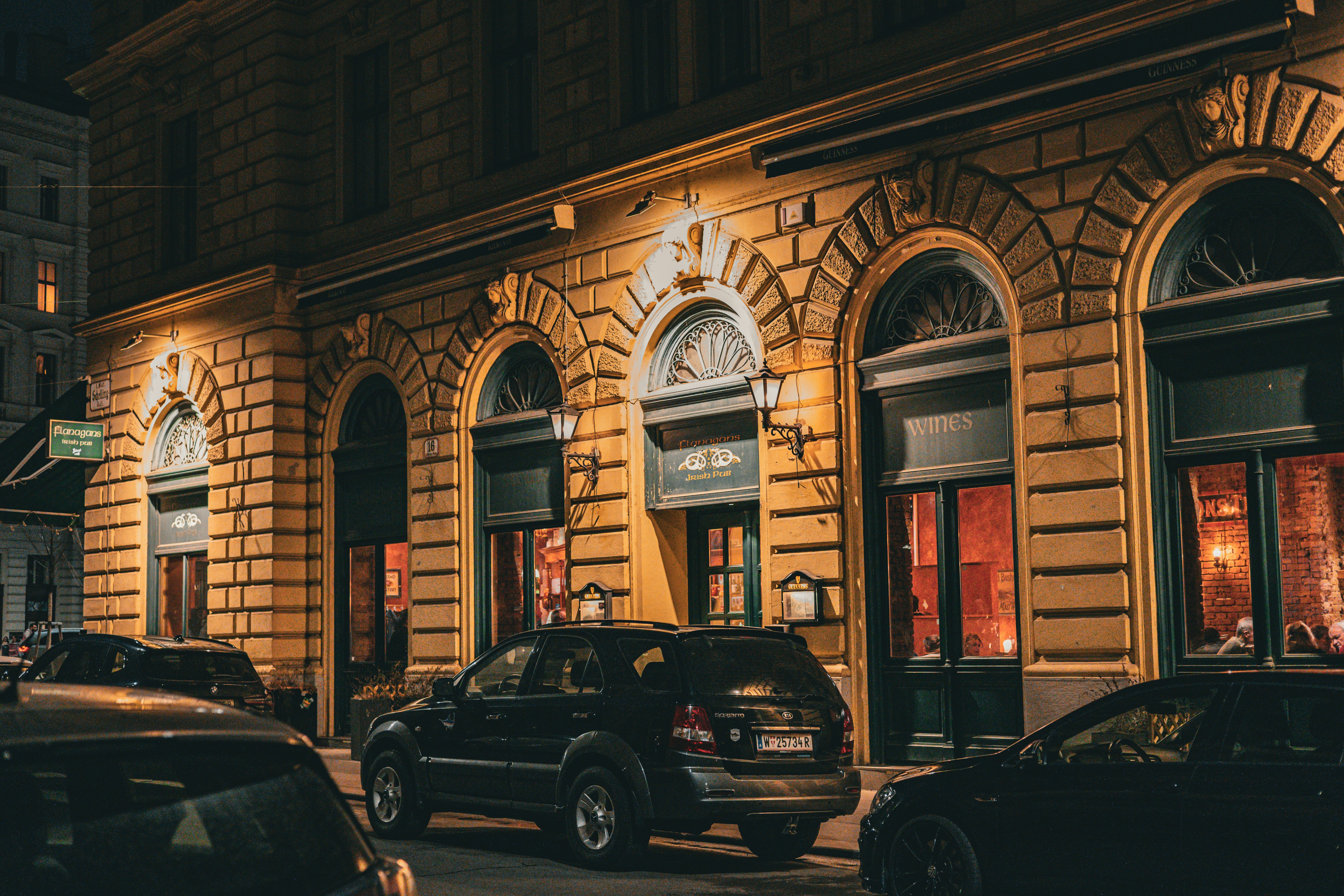 Cars parked outside a building at night