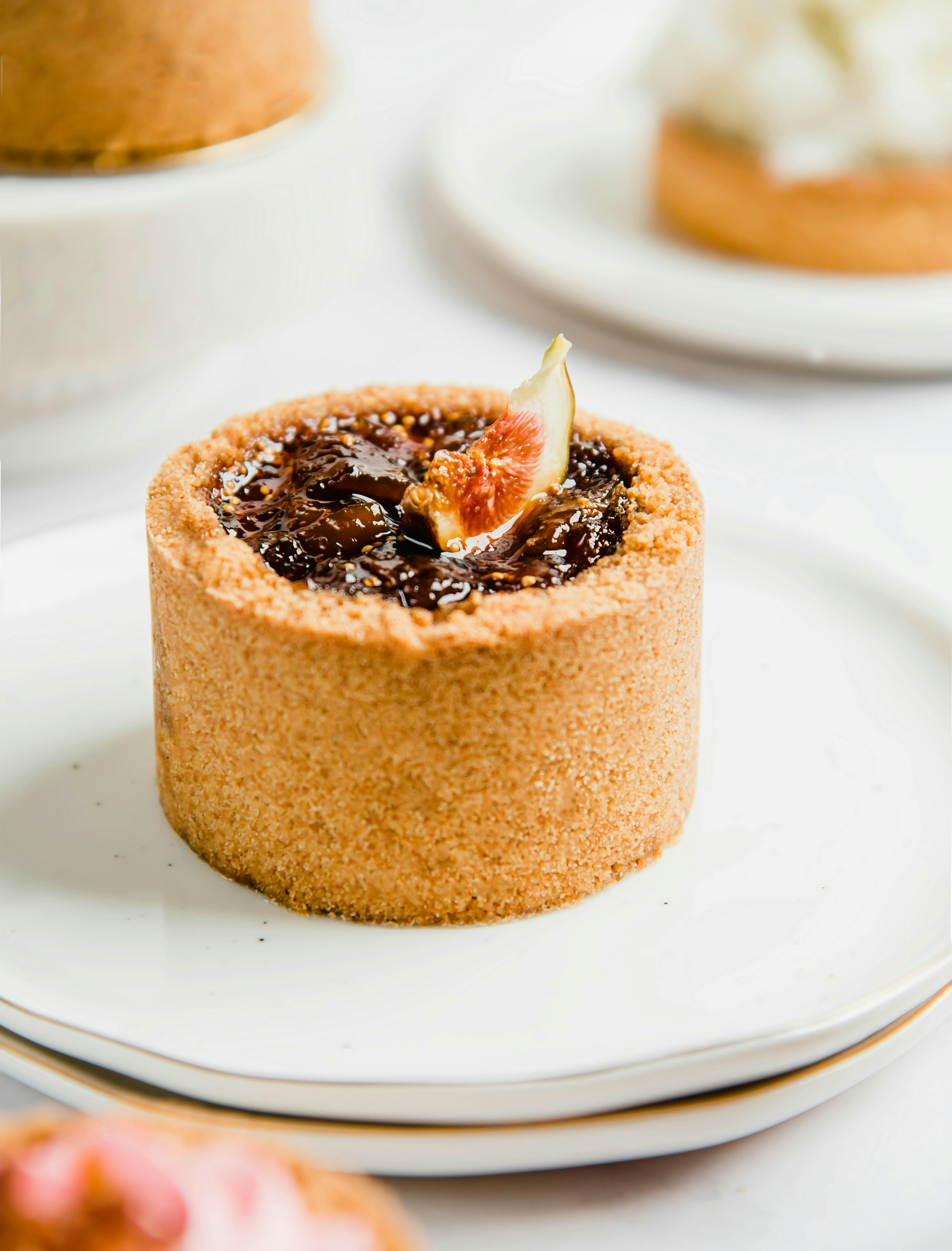 A fig tartlet on a white plate