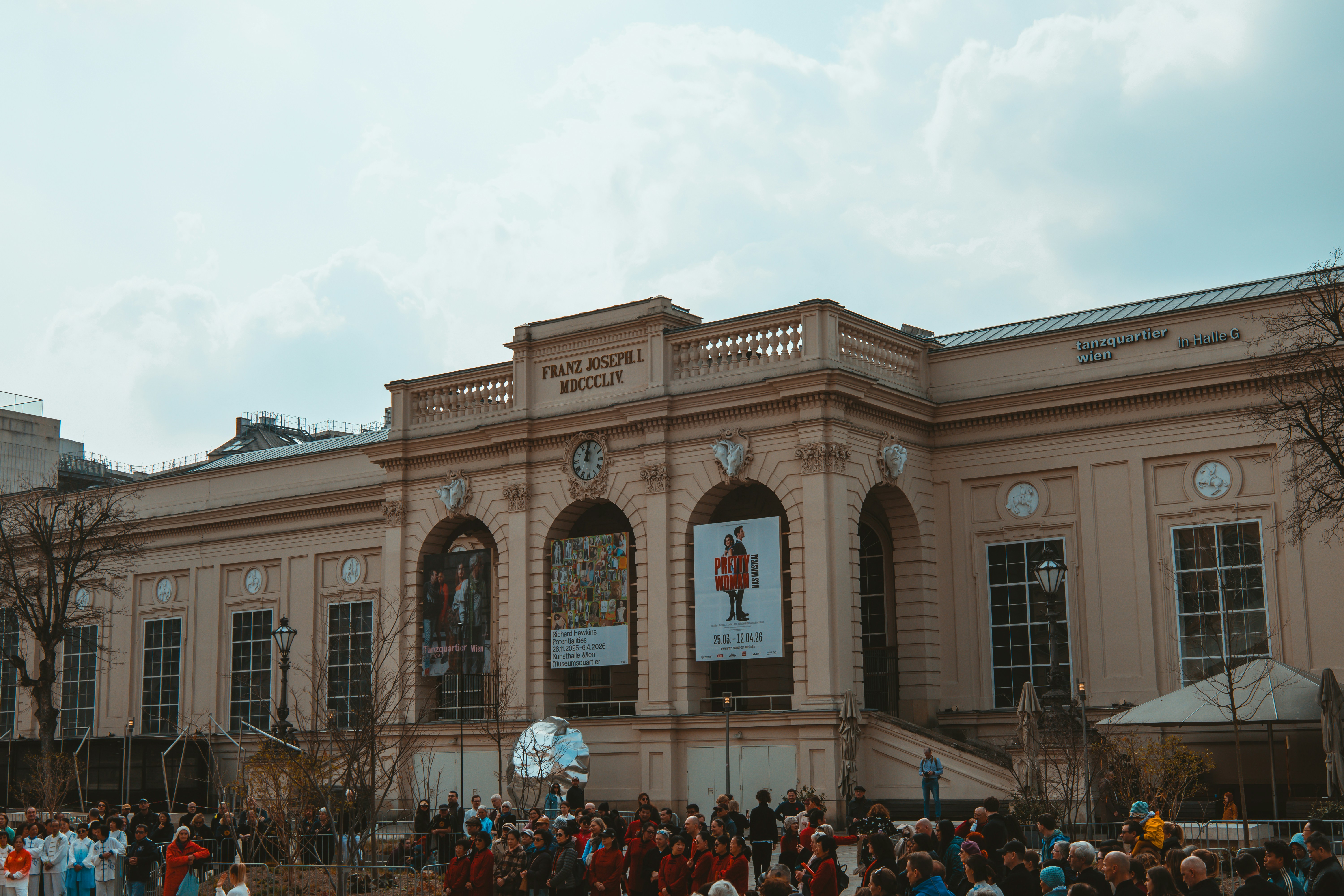 A large building with people gathered outside