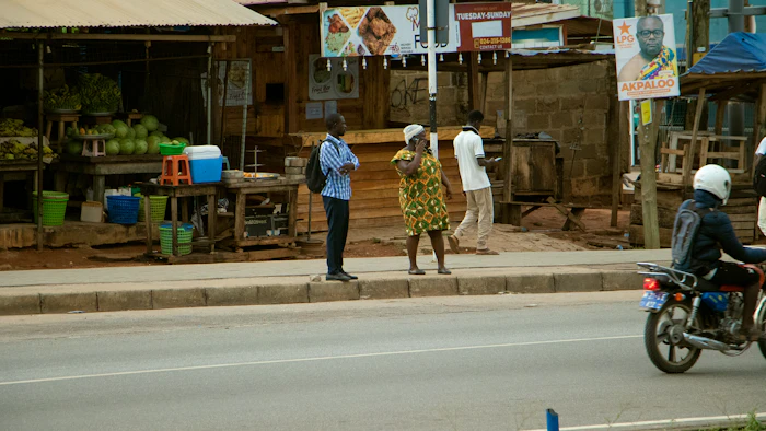 Street vendors and fresh produce at a neighborhood market in Ghana