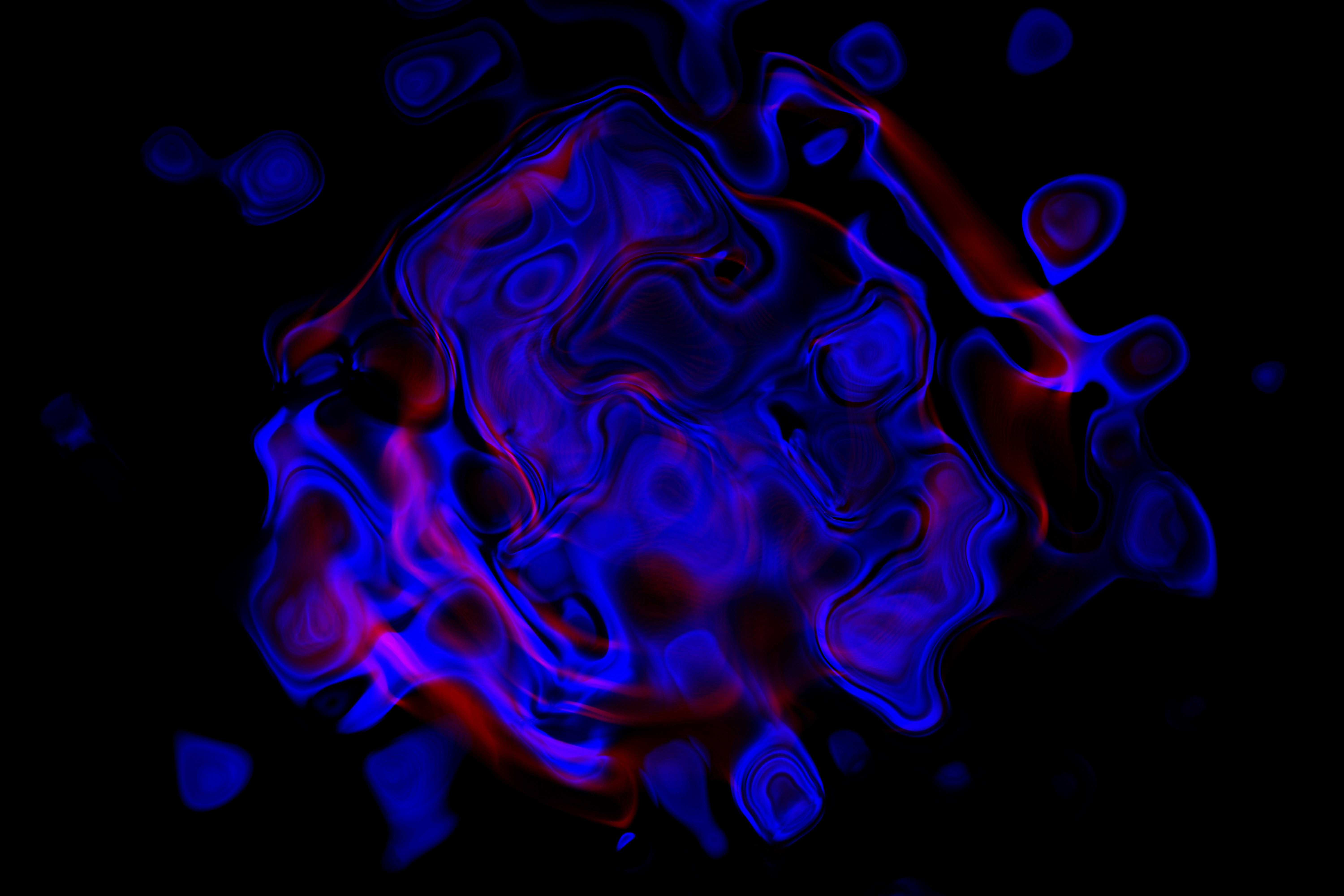 Abstract swirling blue and red smoke on black background.