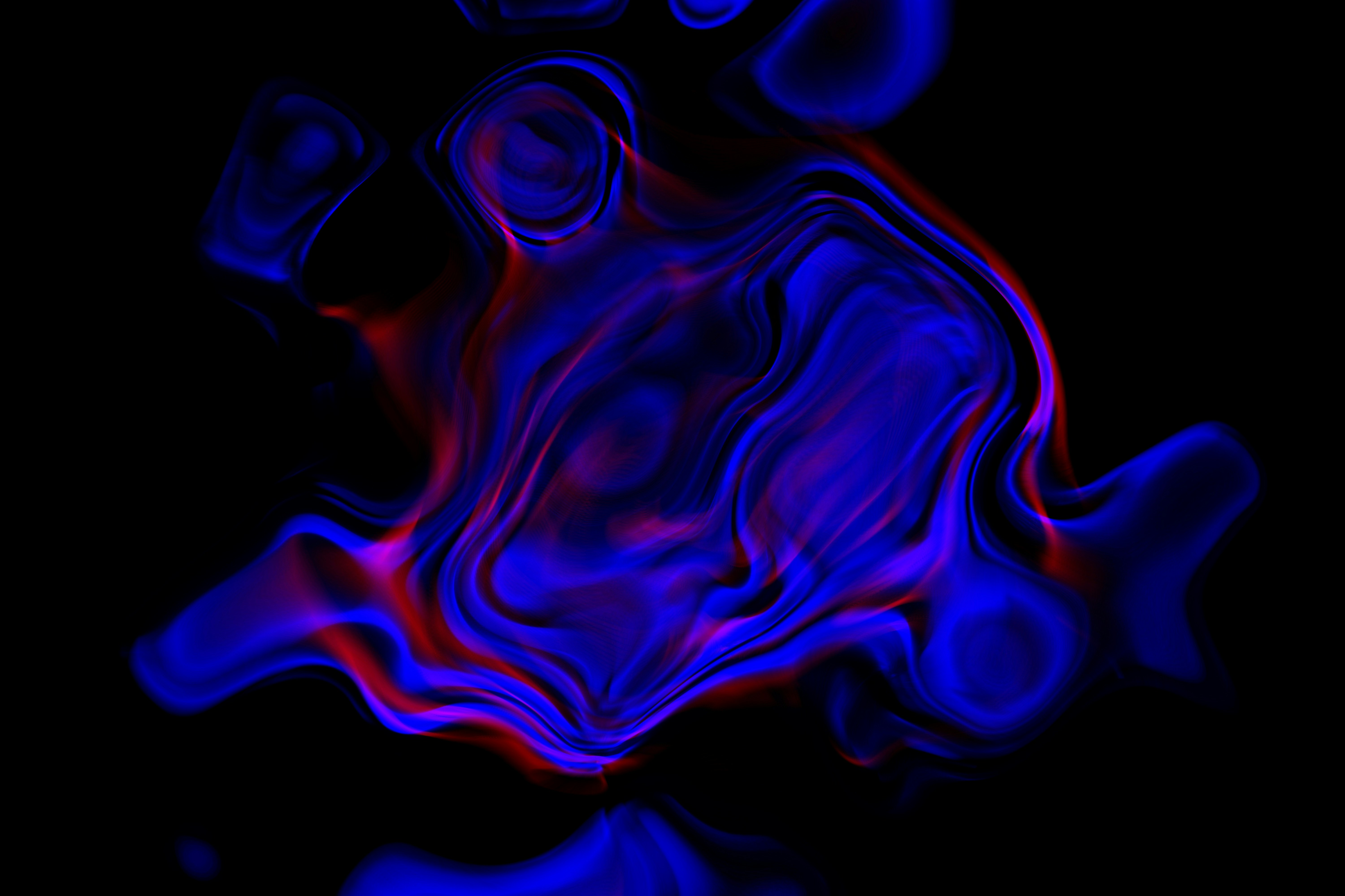 Abstract blue and red swirling smoke on black background