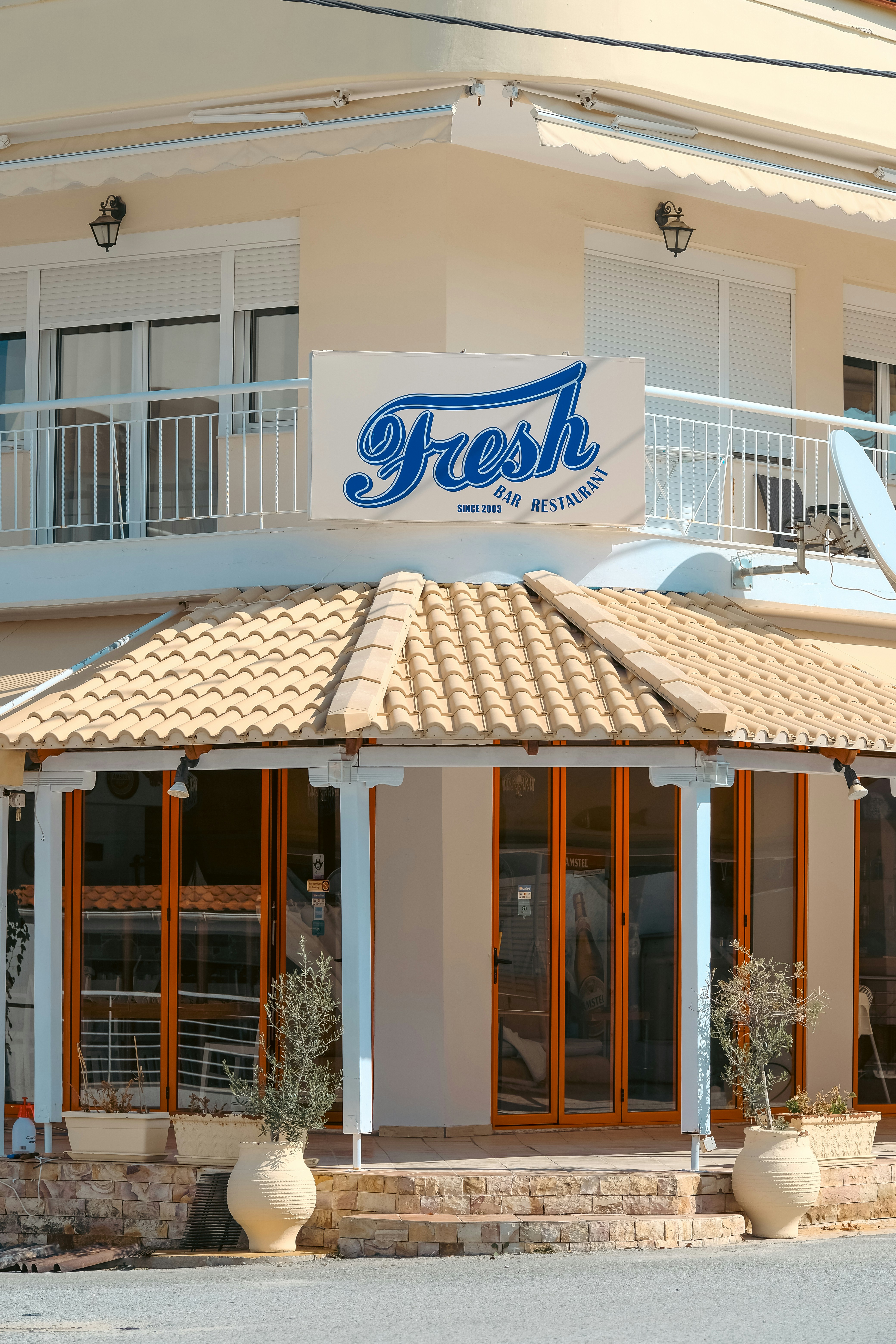 Restaurant with a tiled roof and outdoor seating