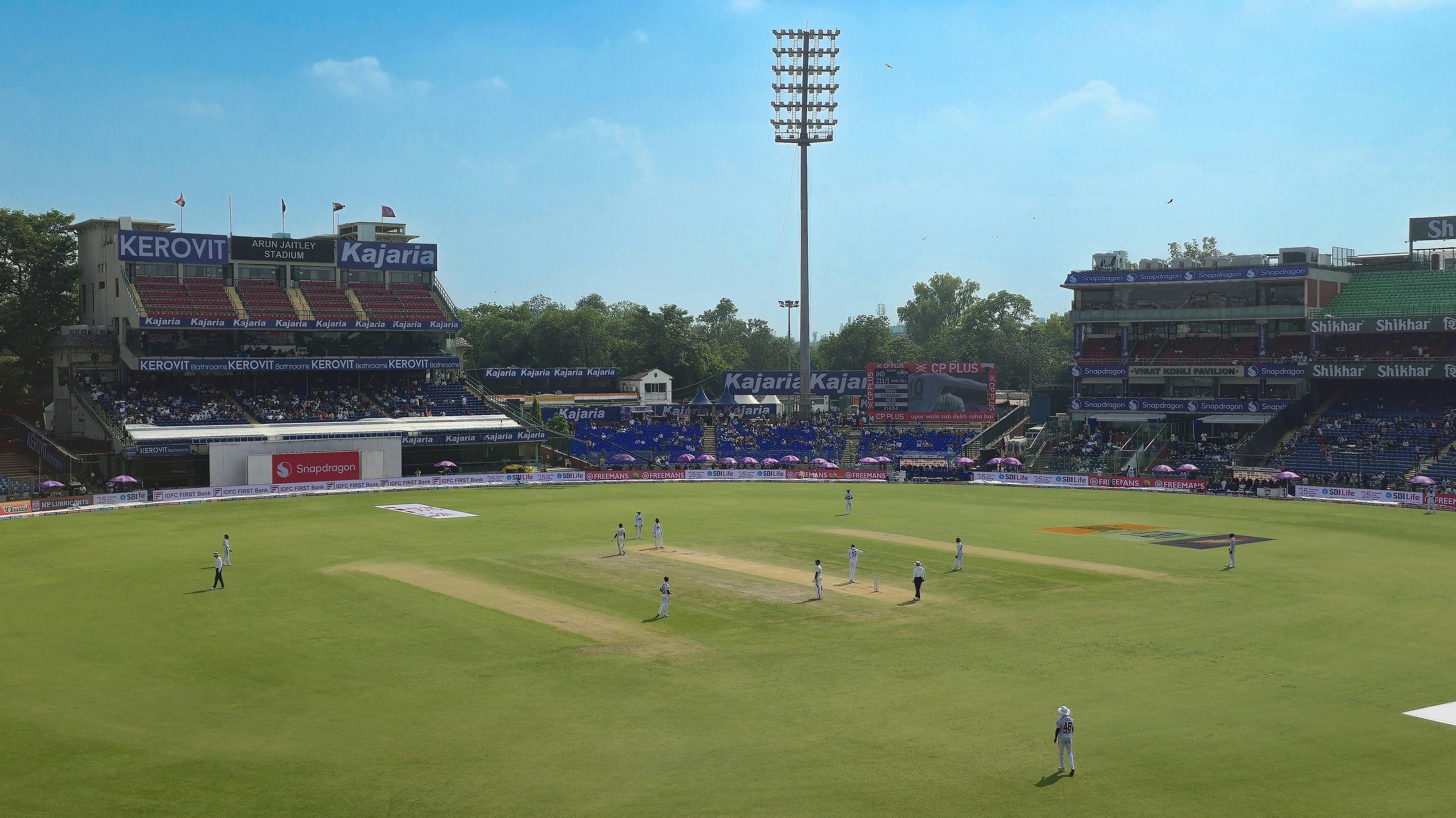 Cricket stadium with players on the field