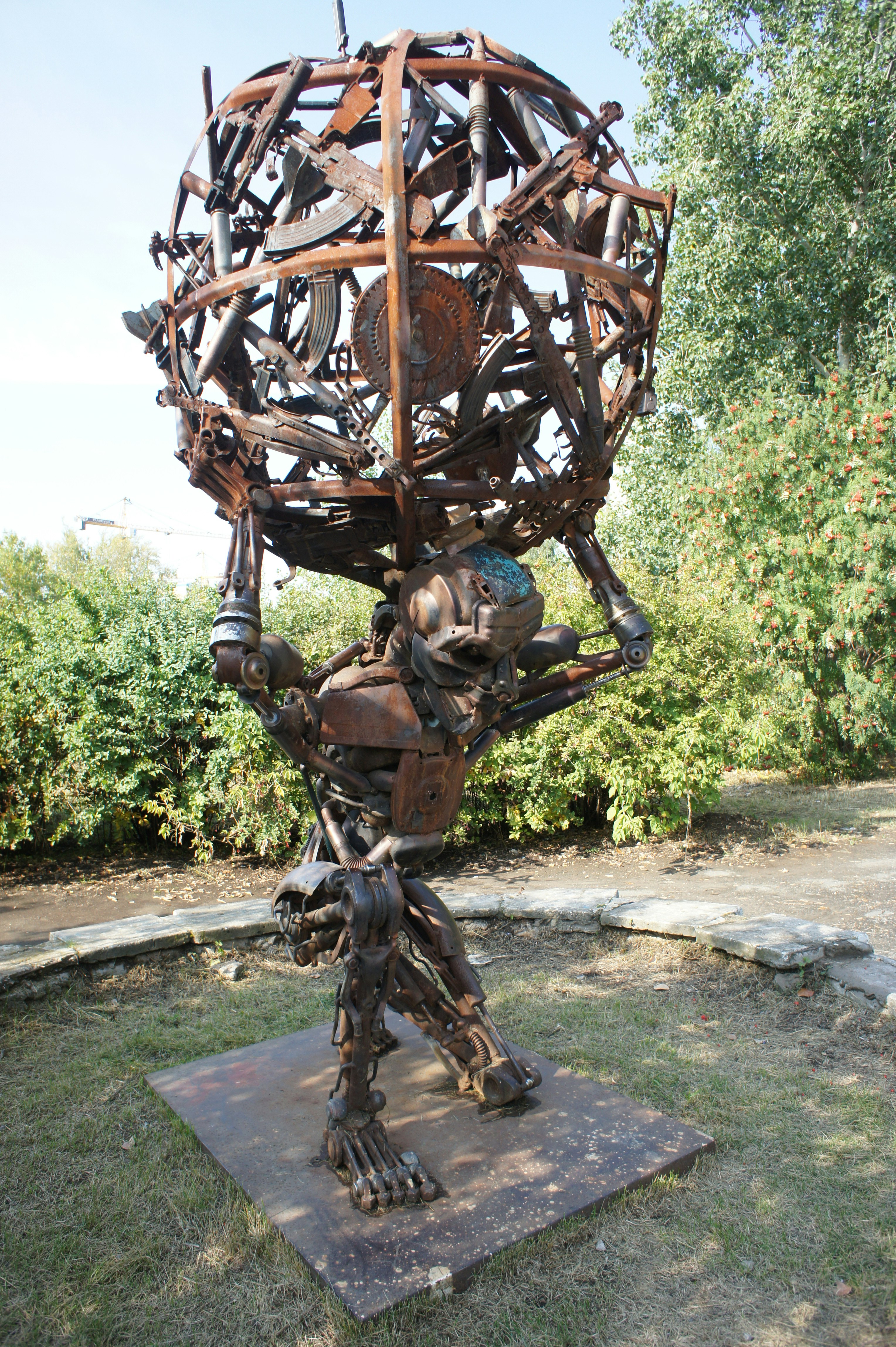 Scrap metal sculpture of atlas holding a globe