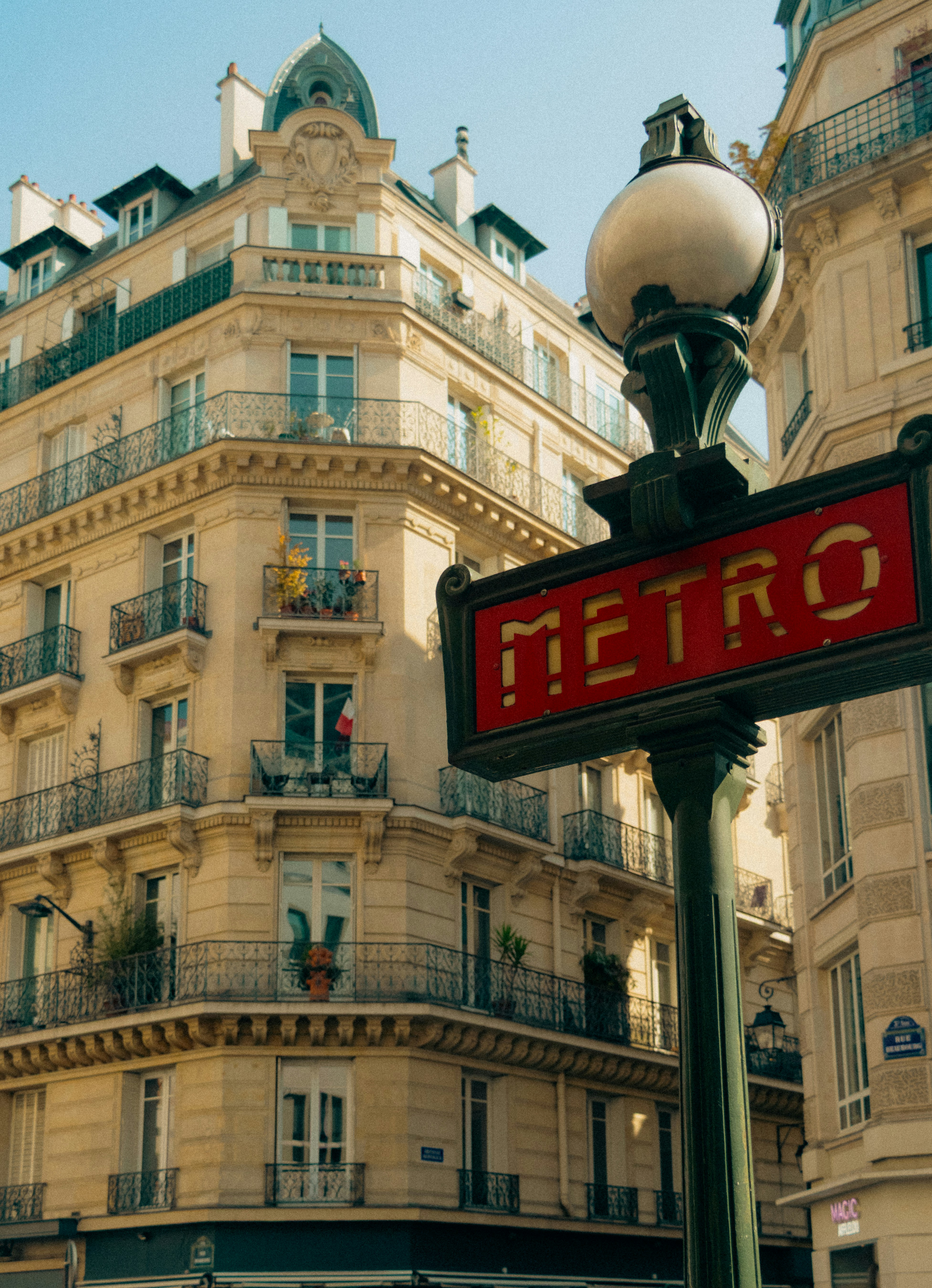 Parisian building with a red metro sign