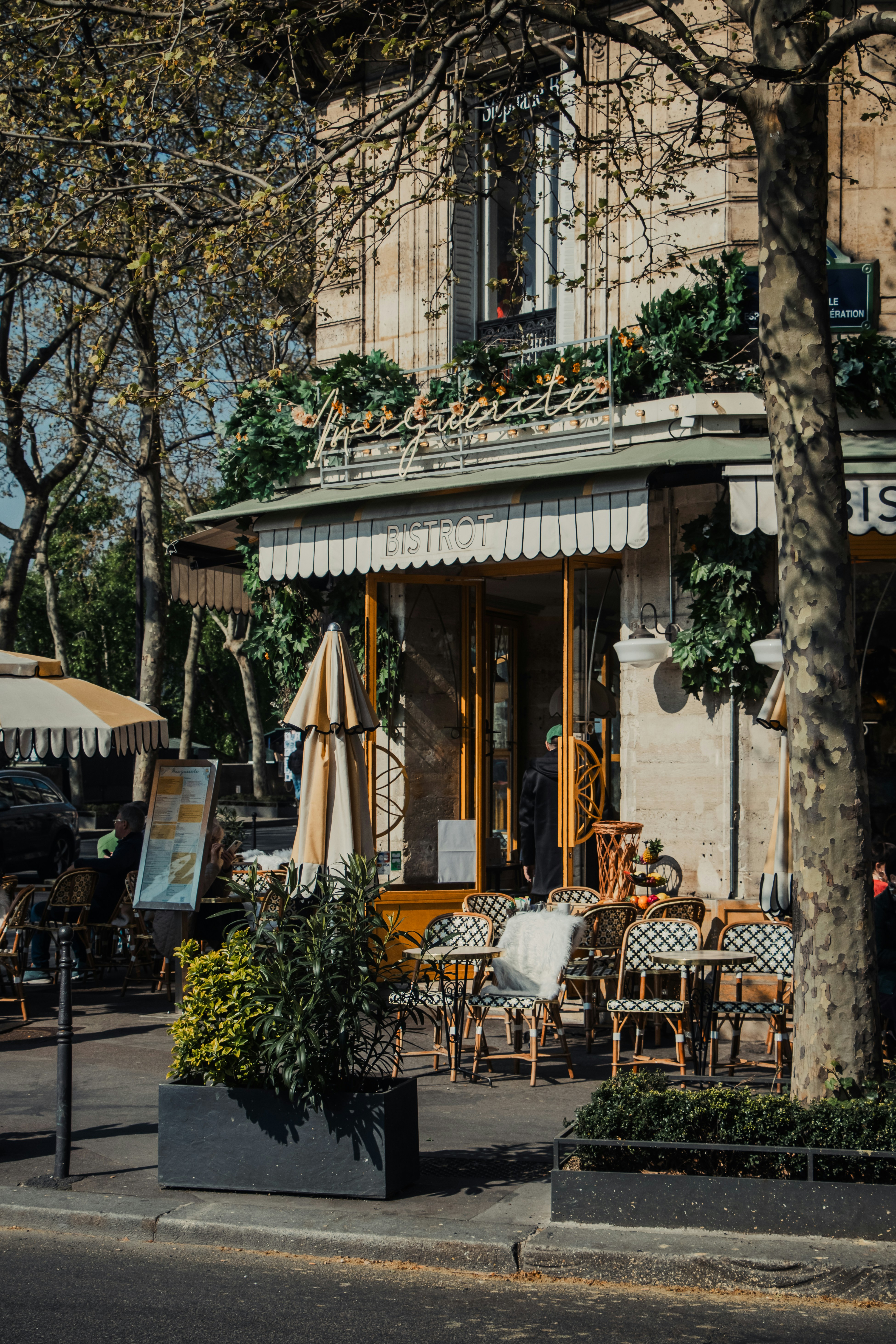 Outdoor cafe seating in front of a parisian building