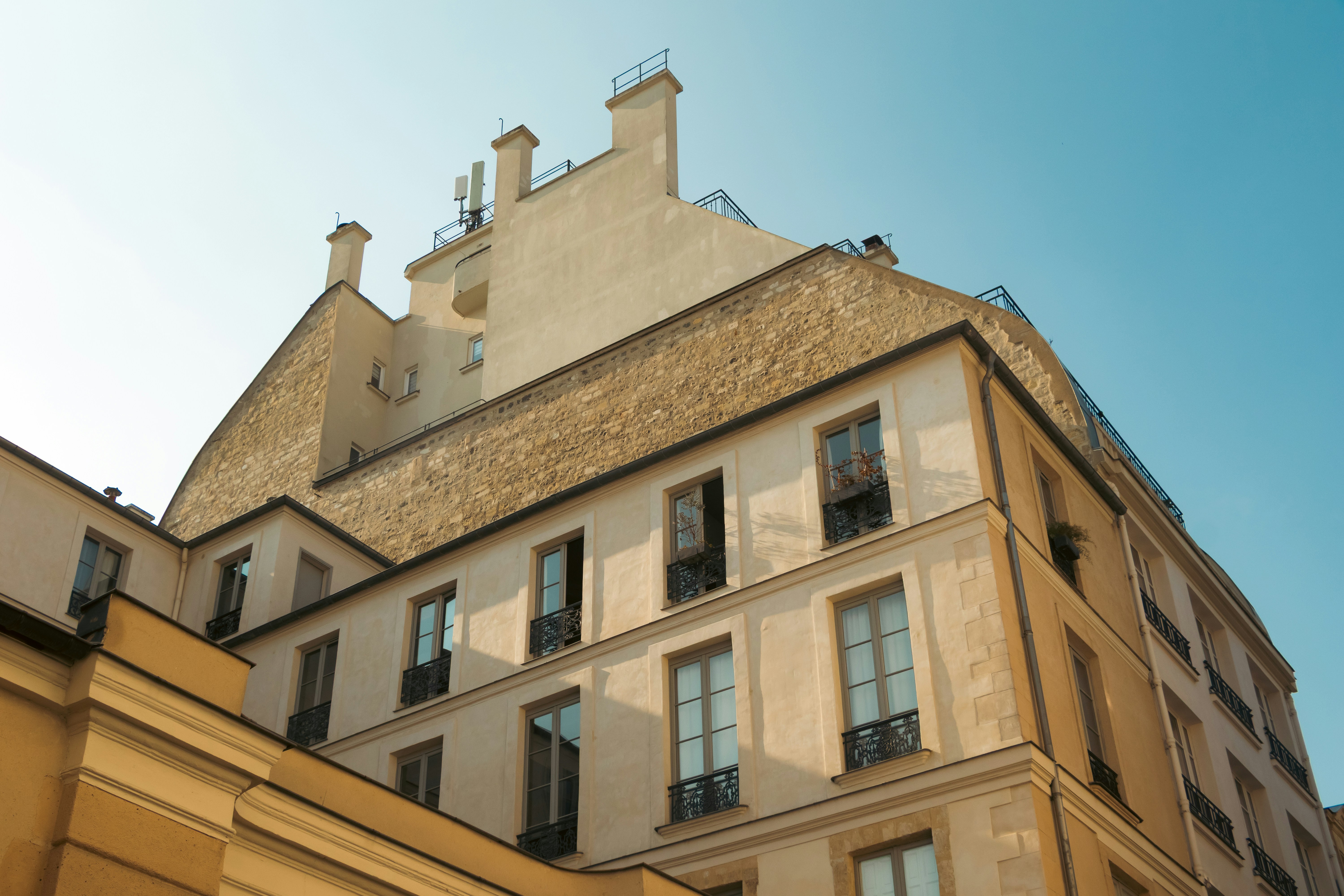 Apartment buildings with many windows under blue sky