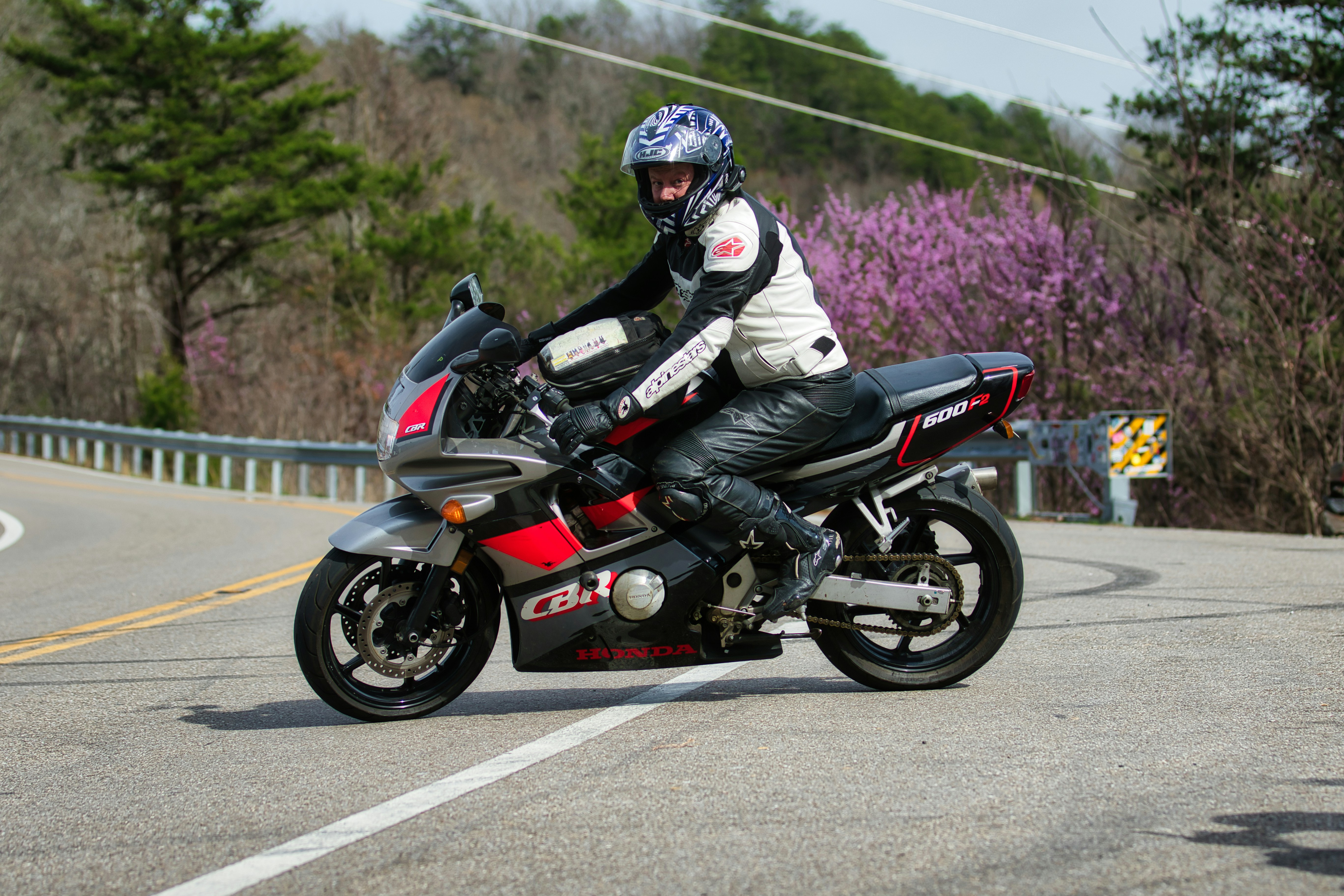 A person riding a motorcycle on a winding road.
