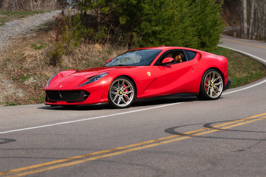 Red Ferrari on an open mountain road