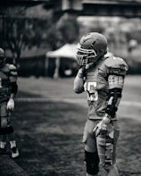 Football player in uniform standing on field