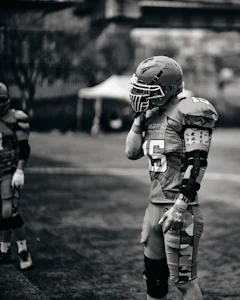 Football player in uniform and helmet on the field