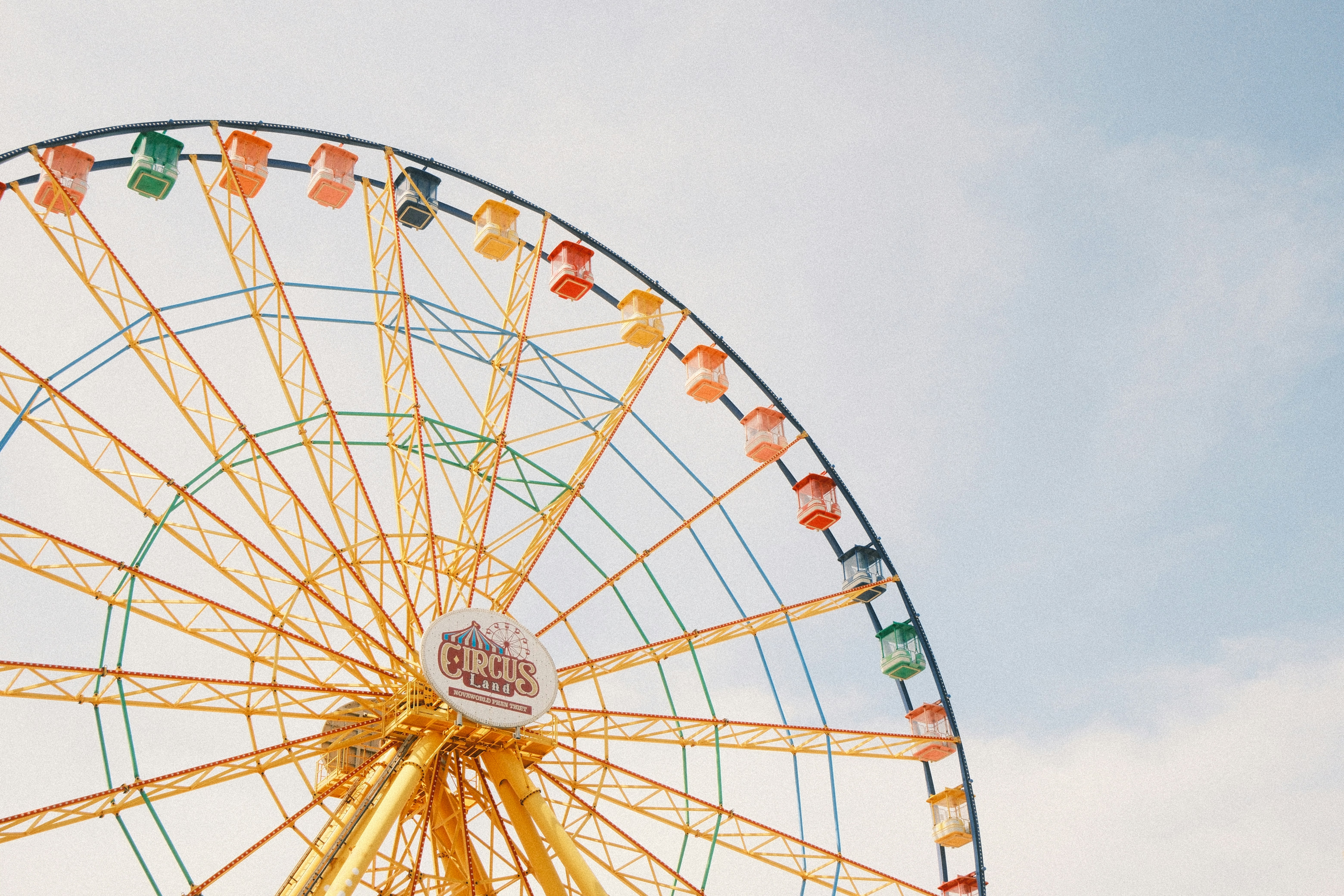 A colorful ferris wheel against a pale sky